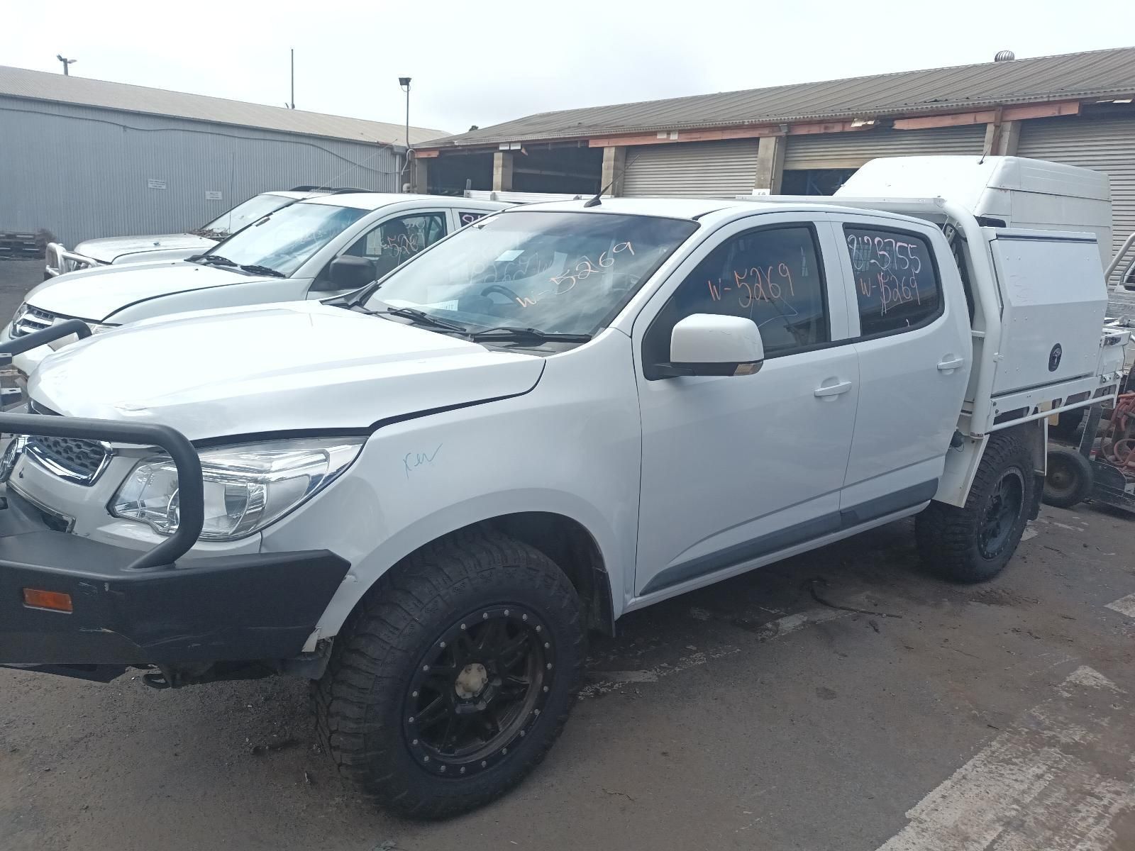 A Row of White Trucks Are Parked in a Parking Lot — South West 4WD Wreckers In Brisbane, QLD