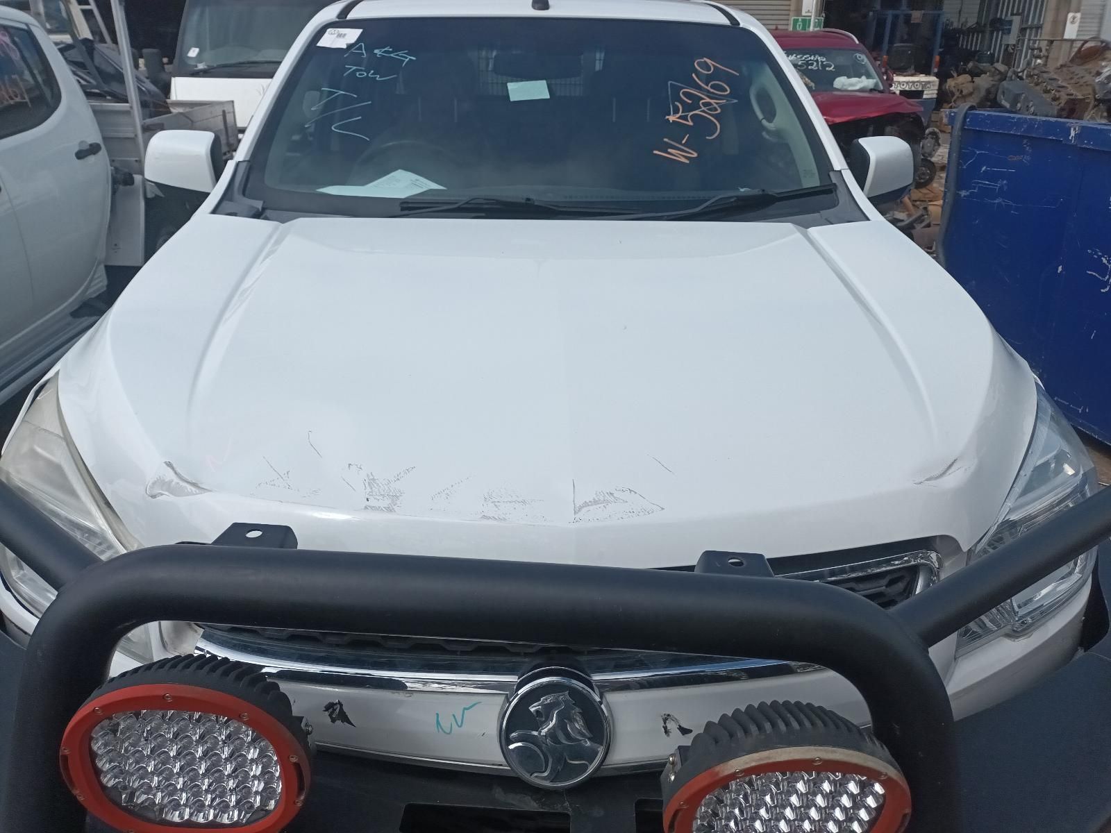 A White Car with a Black Bumper is Parked in a Parking Lot — South West 4WD Wreckers In Brisbane, QLD