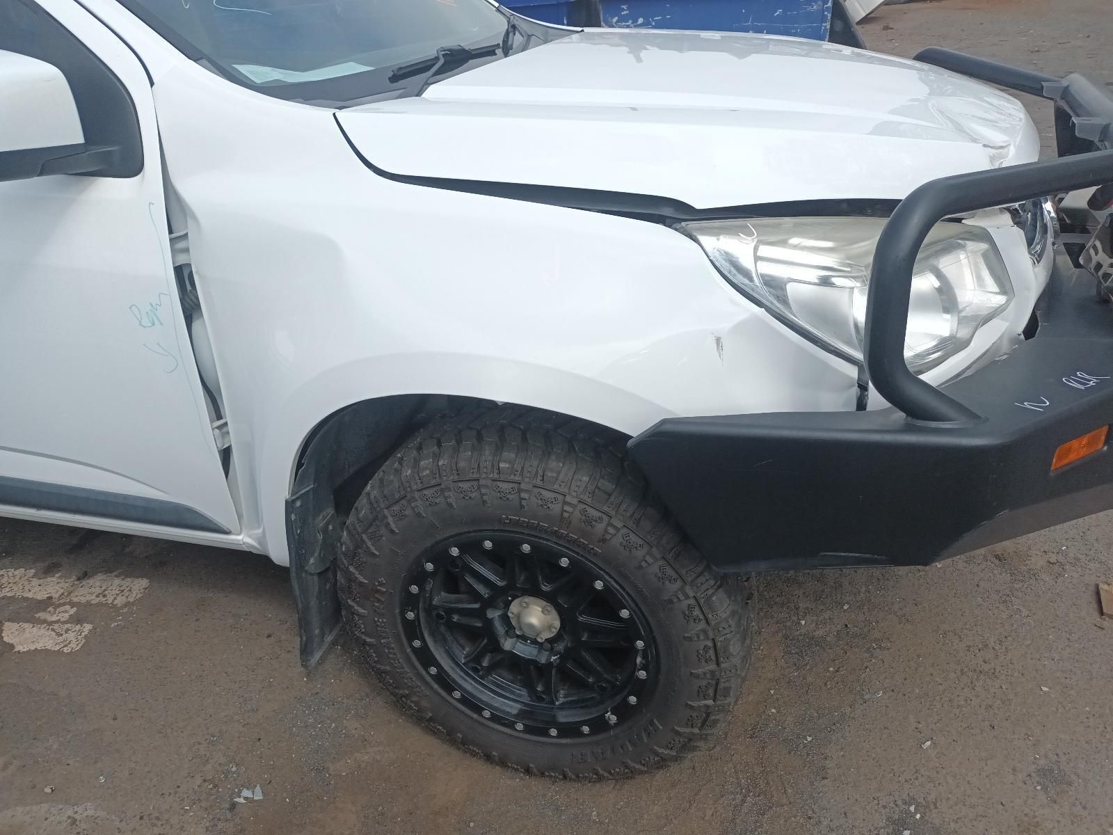 A White Truck with a Black Bumper is Parked on the Side of the Road — South West 4WD Wreckers In Brisbane, QLD