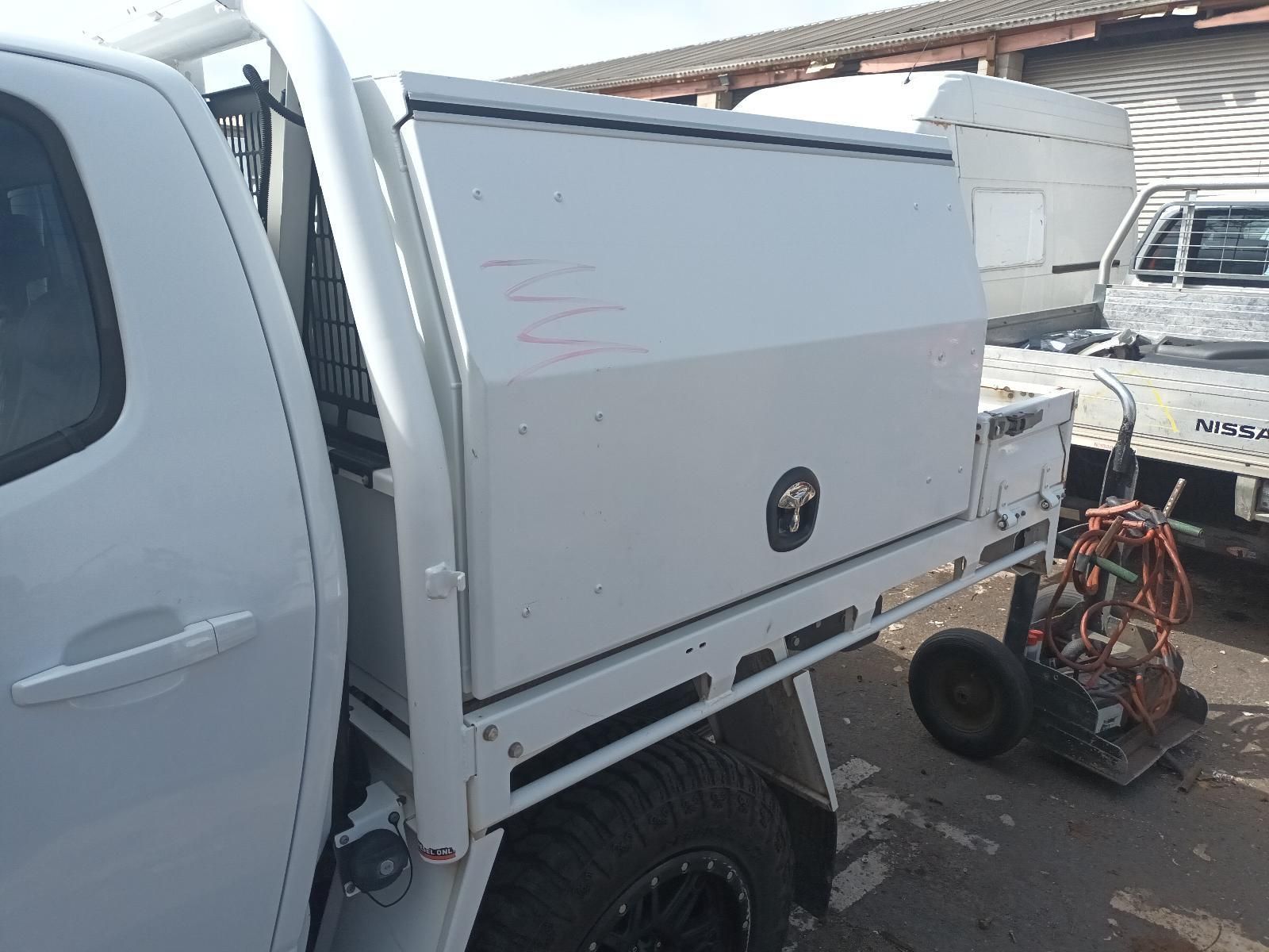 A White Truck with a Toolbox in the Back is Parked in a Parking Lot — South West 4WD Wreckers In Brisbane, QLD