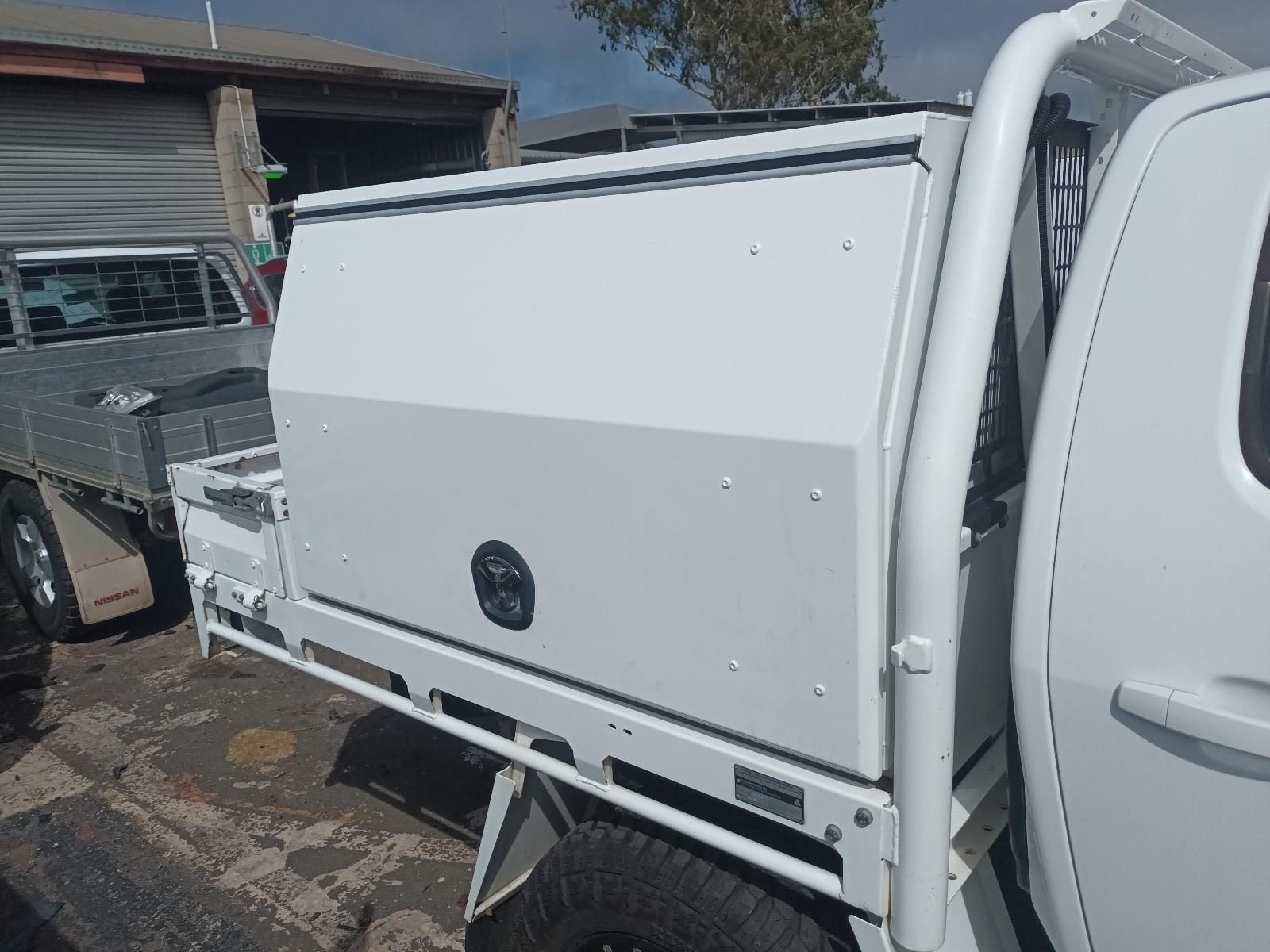A White Truck with a Toolbox on the Back is Parked in a Parking Lot — South West 4WD Wreckers In Brisbane, QLD