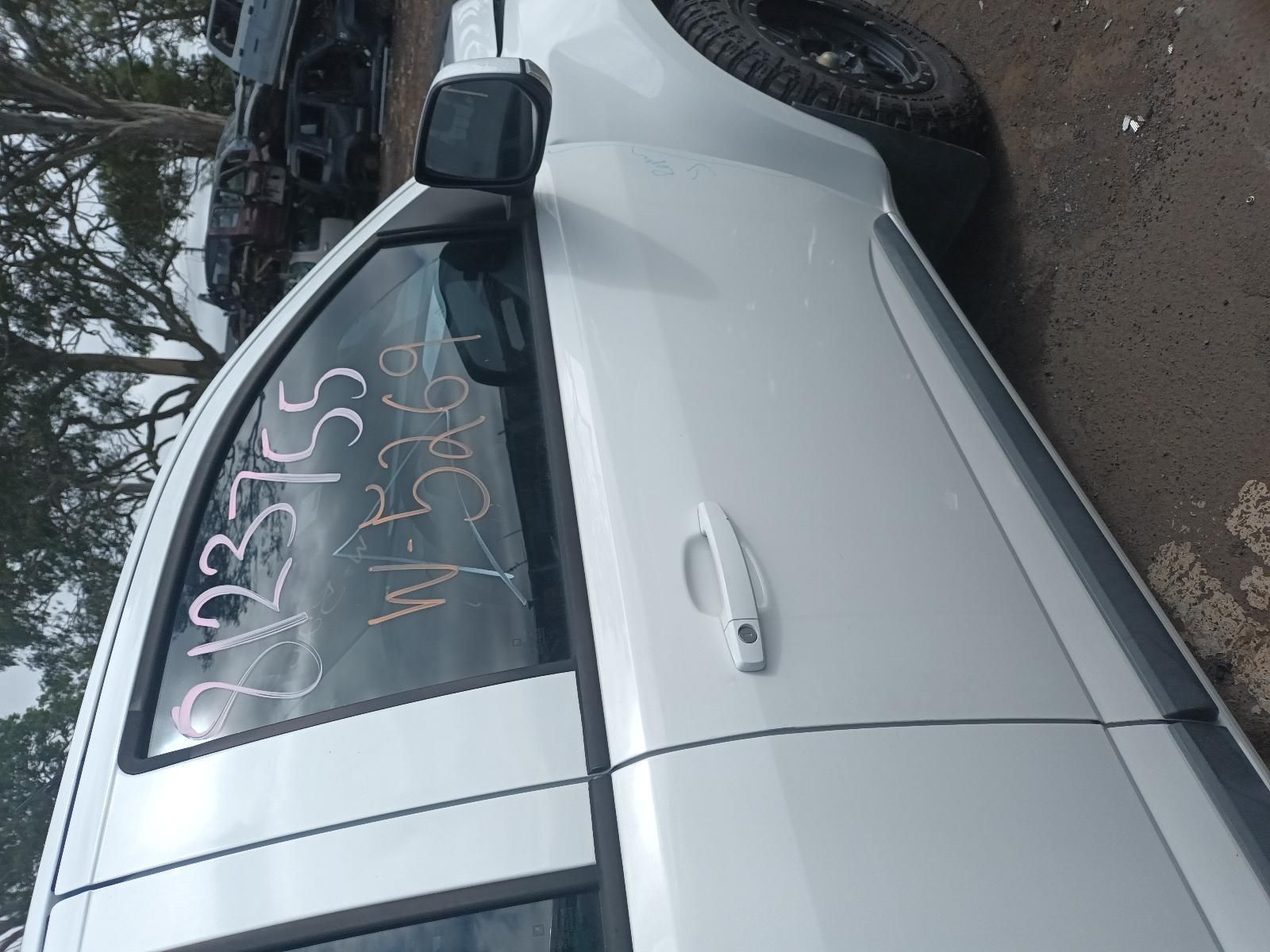 A White Car is Parked on the Side of the Road — South West 4WD Wreckers In Brisbane, QLD