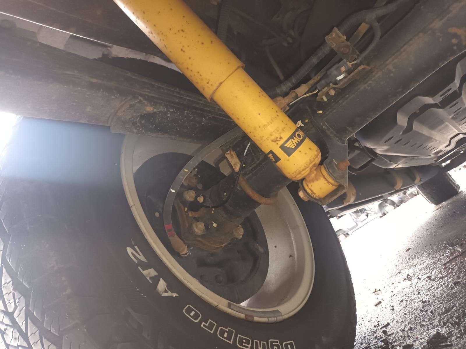 A Yellow Shock Absorber is Attached to a Tire — South West 4WD Wreckers In Brisbane, QLD