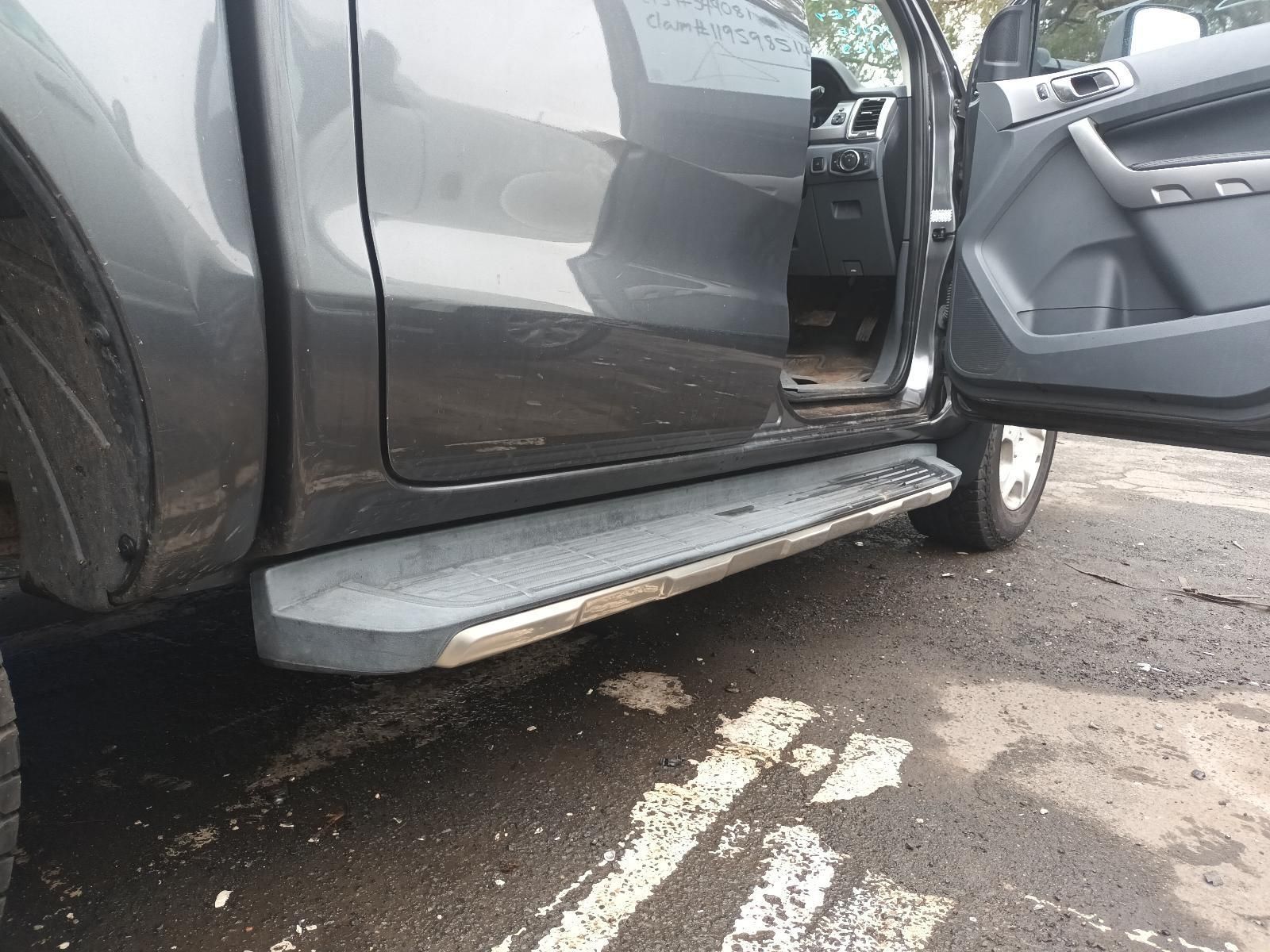 A Gray Truck with Its Doors Open is Parked on the Side of the Road — South West 4WD Wreckers In Brisbane, QLD