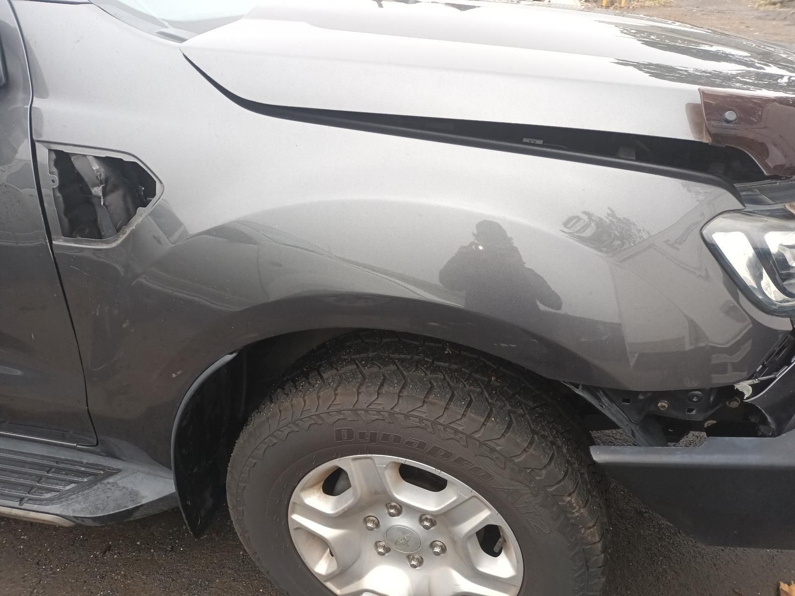 A Gray Truck with a Broken Hood is Parked on the Side of the Road — South West 4WD Wreckers In Brisbane, QLD
