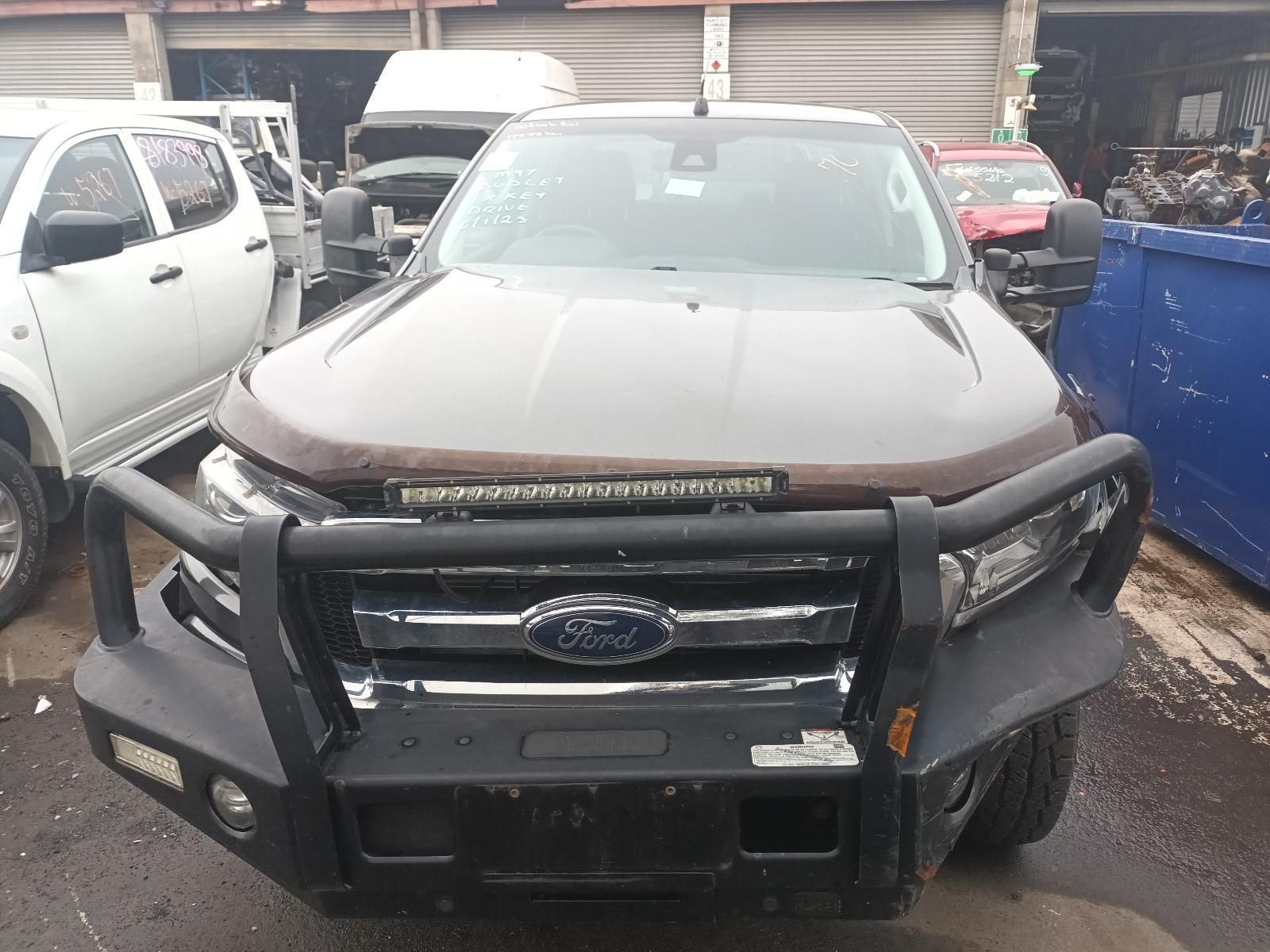 A Ford Truck is Parked in Front of a Garage — South West 4WD Wreckers In Brisbane, QLD