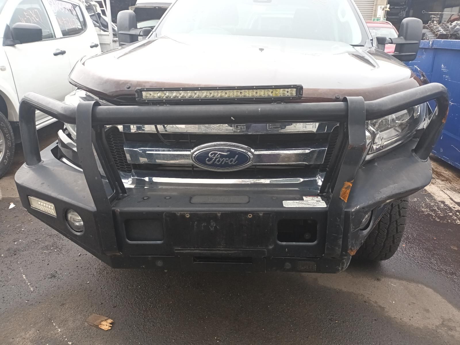 A Brown Ford Truck with a Black Bumper is Parked in a Parking Lot — South West 4WD Wreckers In Brisbane, QLD