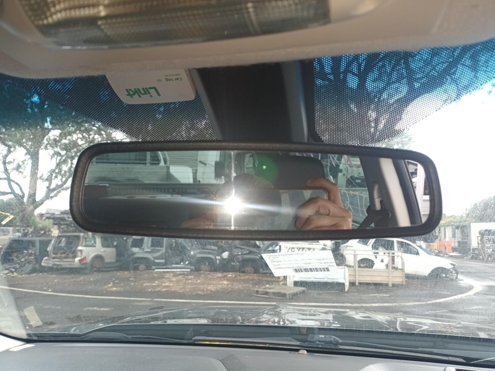 A Person is Taking a Picture of Their Reflection in the Rear View Mirror — South West 4WD Wreckers In Brisbane, QLD