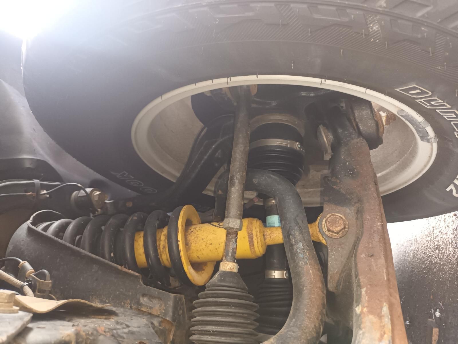 A Close Up of the Underside of a Car with a Tire That Says Bridgestone — South West 4WD Wreckers In Brisbane, QLD