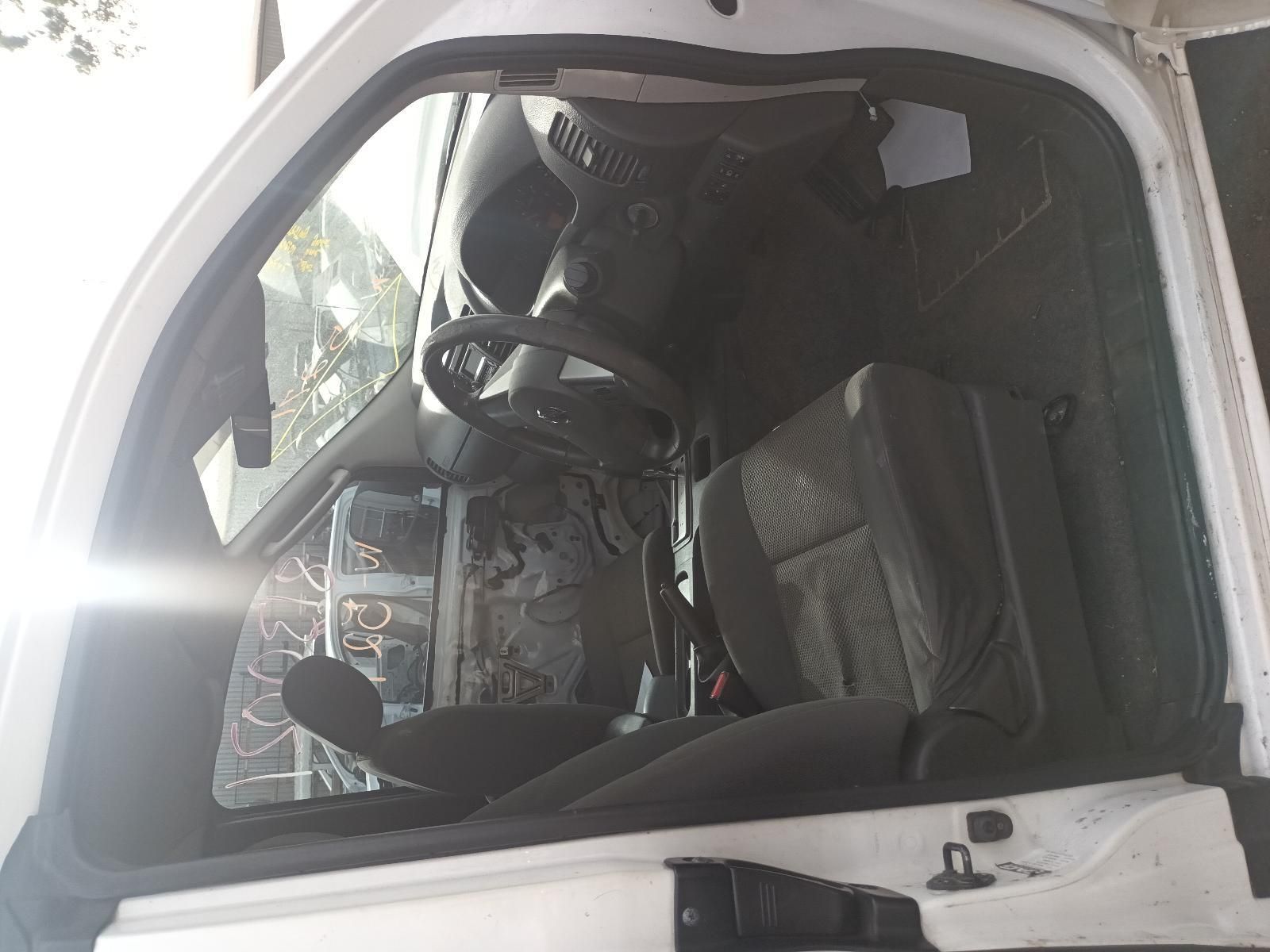 The Inside of a White Car with the Door Open and the Steering Wheel Visible — South West 4WD Wreckers In Brisbane, QLD