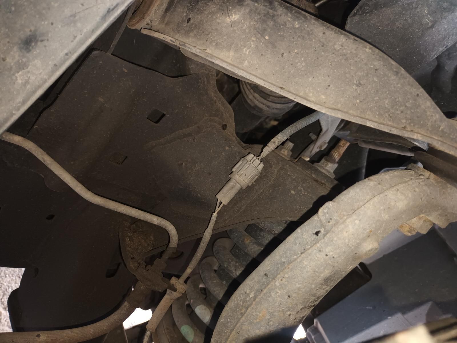 A Close Up of the Underside of a Car with a Hose Coming Out of It — South West 4WD Wreckers In Brisbane, QLD