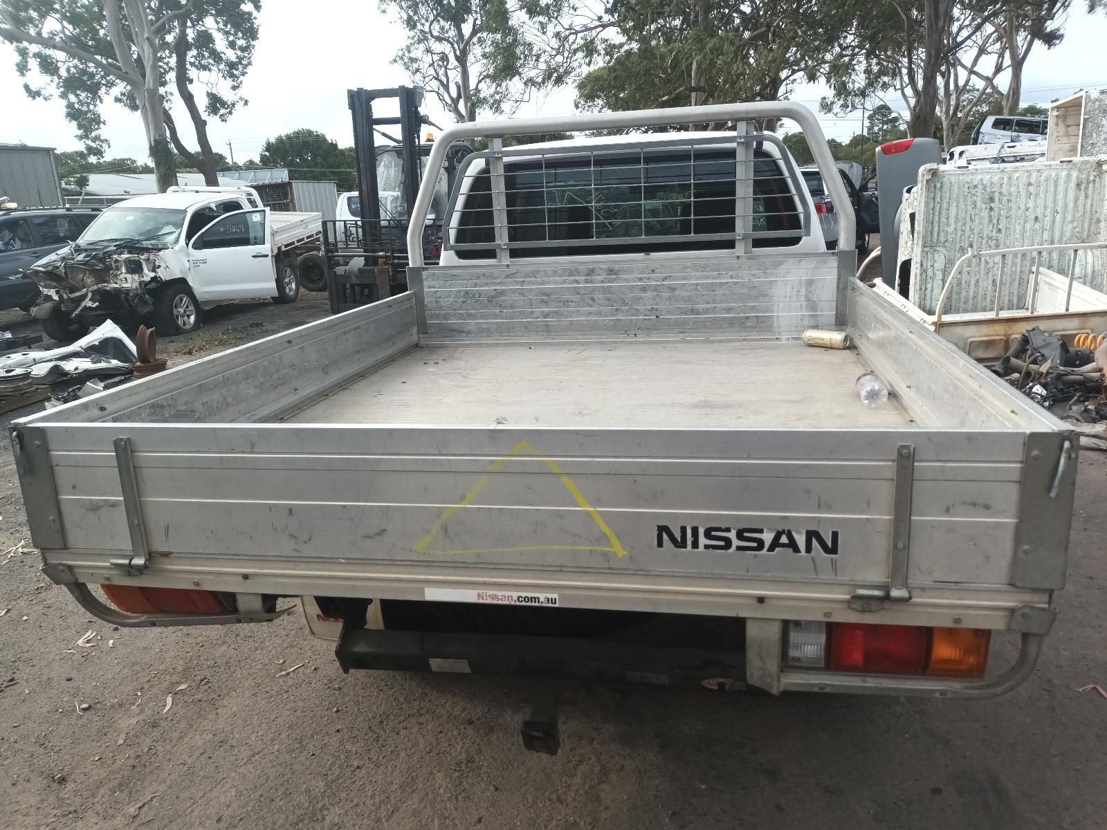 A Nissan Truck is Parked in a Scrap Yard — South West 4WD Wreckers In Brisbane, QLD
