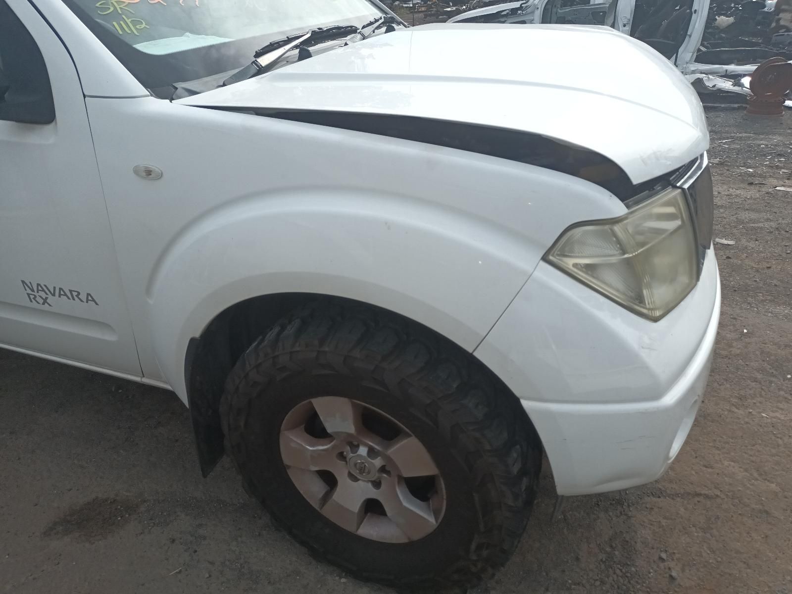 A White Truck with a Black Hood is Parked on a Dirt Road — South West 4WD Wreckers In Brisbane, QLD