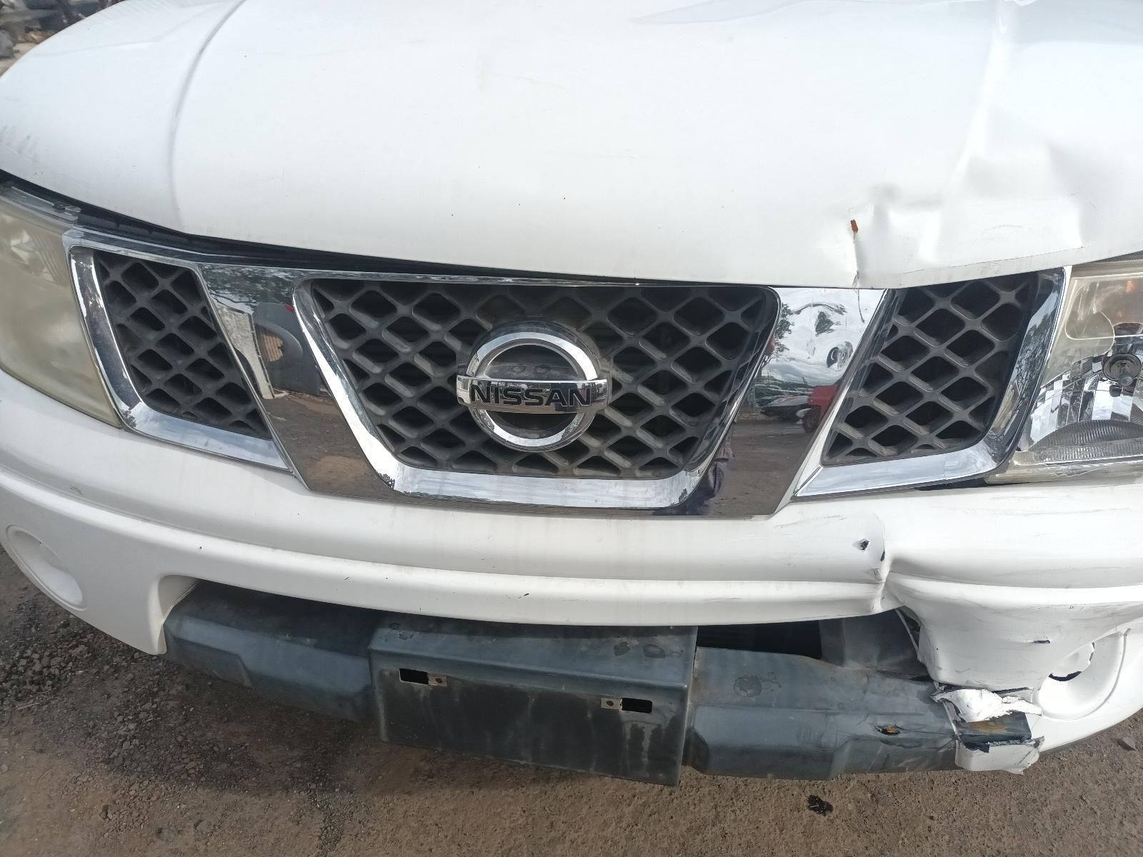 A White Nissan Truck with a Damaged Front Bumper — South West 4WD Wreckers In Brisbane, QLD