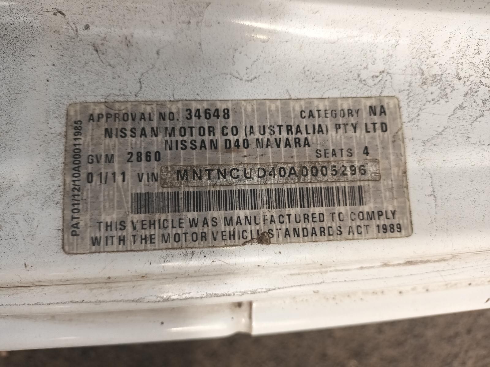 A White Car with a License Plate That Says Nissan Motor Co Australia Pty Ltd — South West 4WD Wreckers In Brisbane, QLD