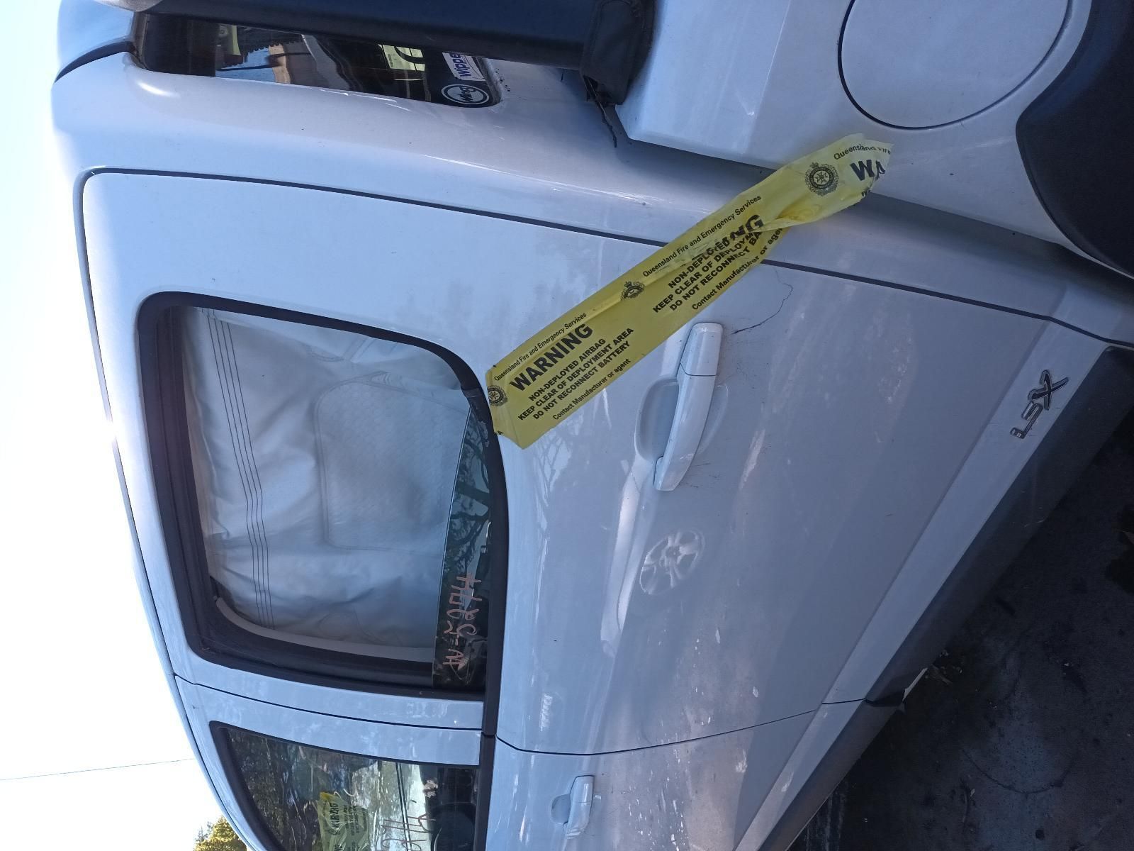 A White Car with a Yellow Warning Tape on It — South West 4WD Wreckers in Harristown, QLD