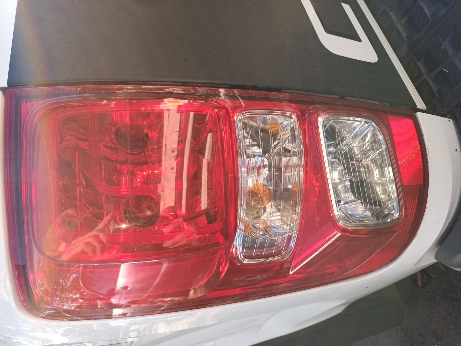 A Close Up of a Red Tail Light on a White Car — South West 4WD Wreckers in Harristown, QLD