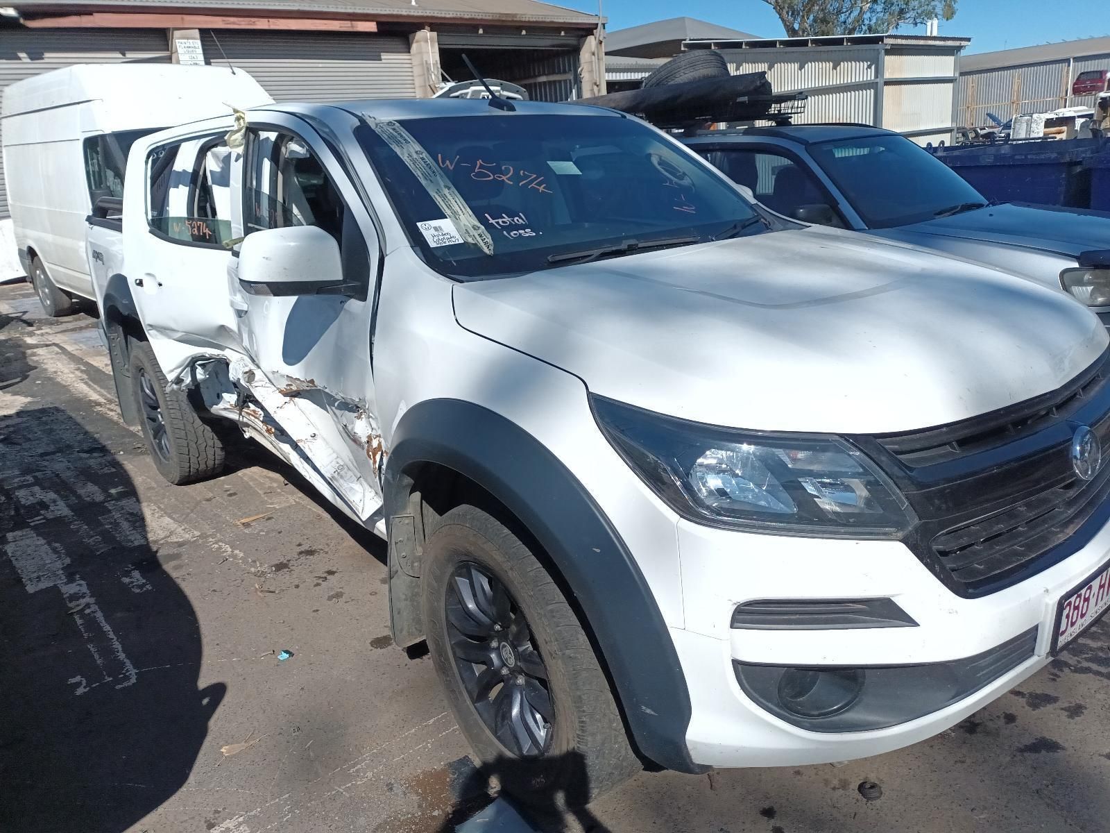 A White Truck with a Damaged Side is Parked in a Parking Lot — South West 4WD Wreckers in Harristown, QLD