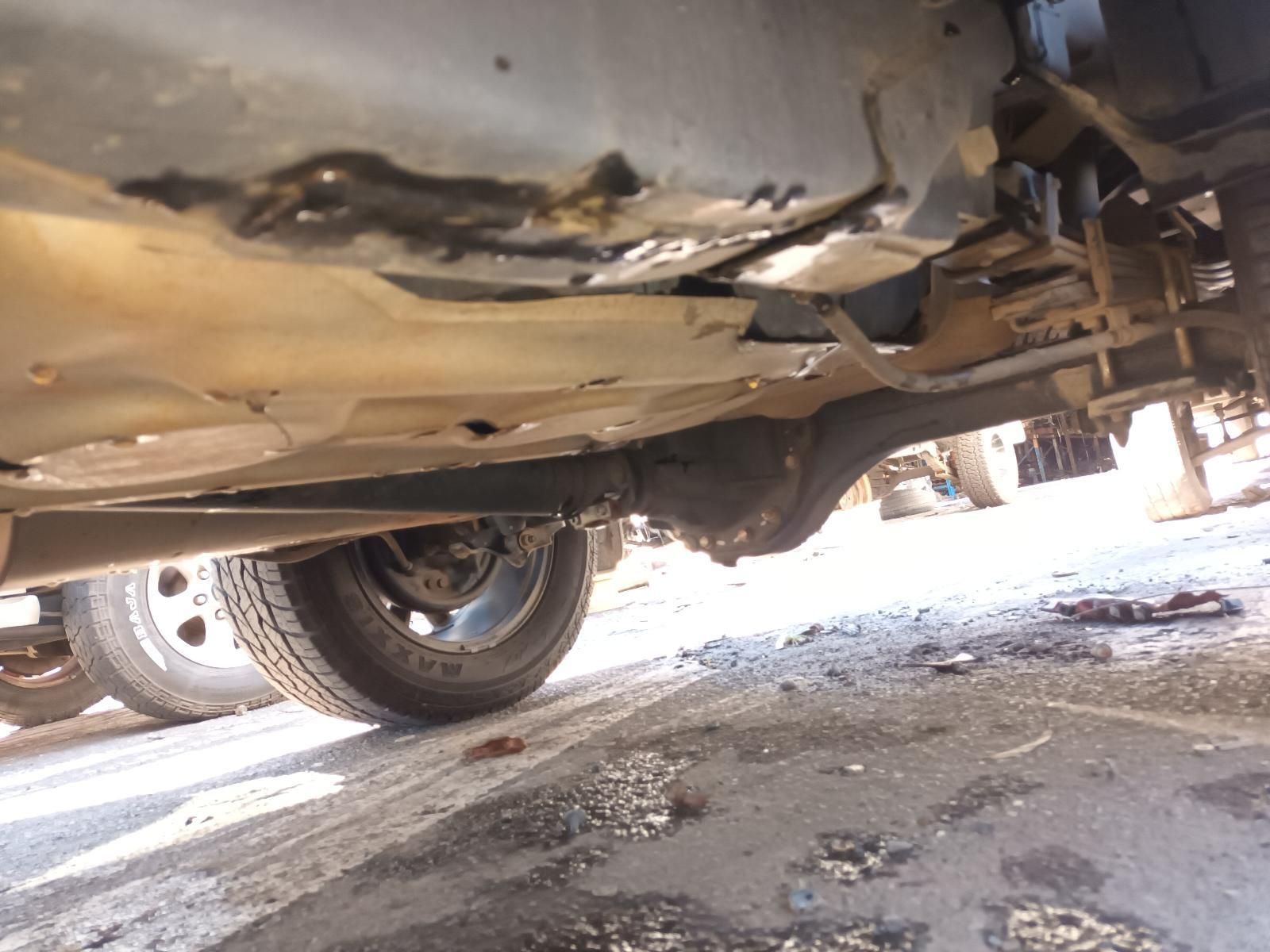 A close up of the underside of a car on a road