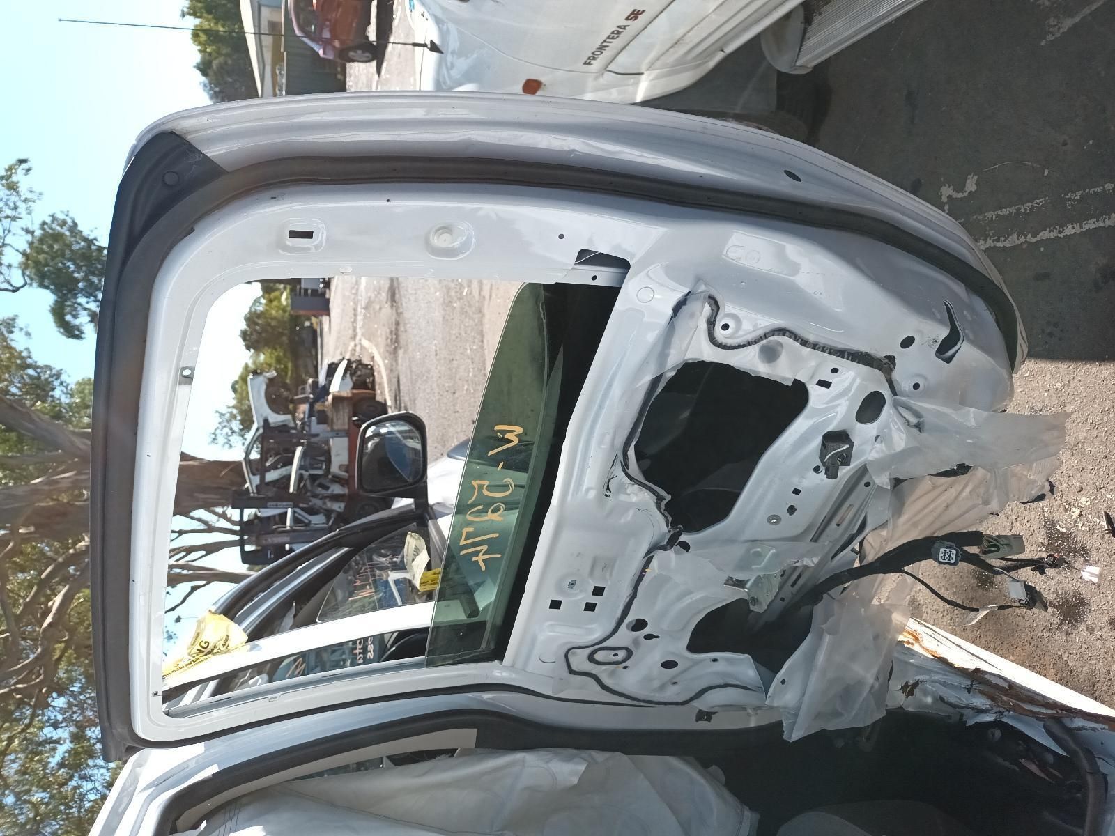 The Trunk of a White Car Has Been Damaged in an Accident — South West 4WD Wreckers in Harristown, QLD