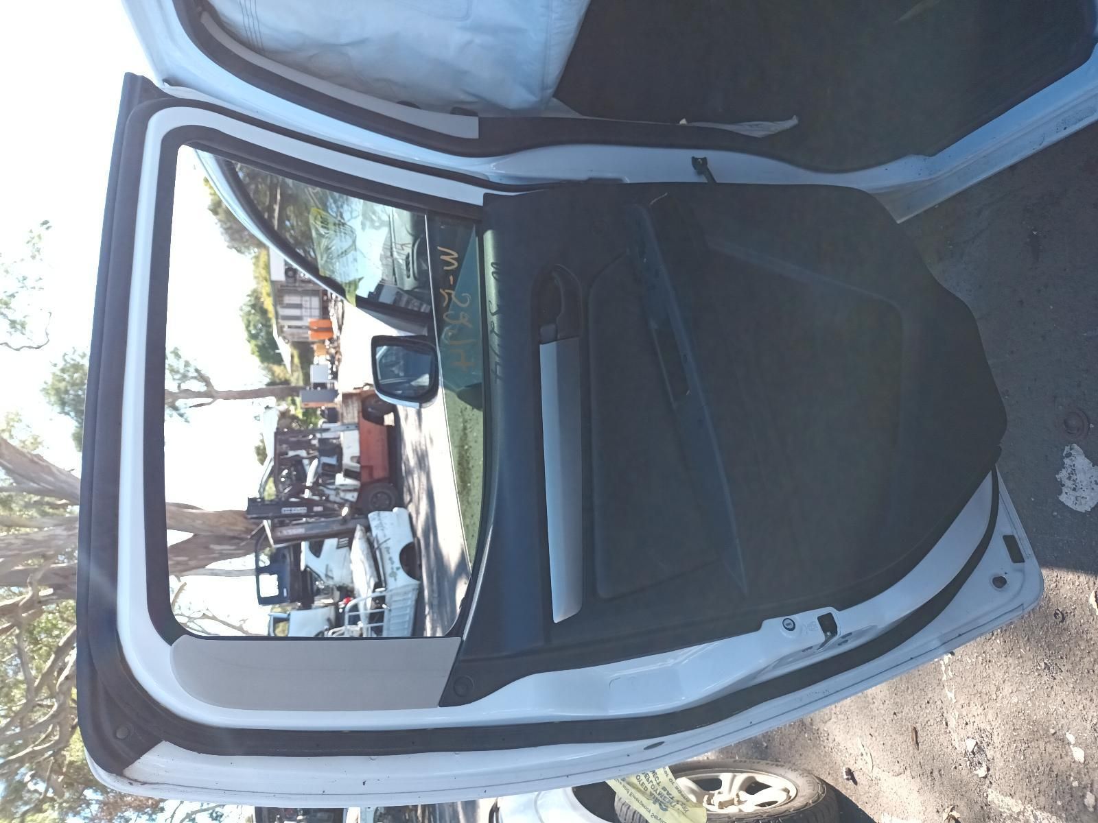 A White Car with the Door Open is Parked on the Side of the Road — South West 4WD Wreckers in Harristown, QLD