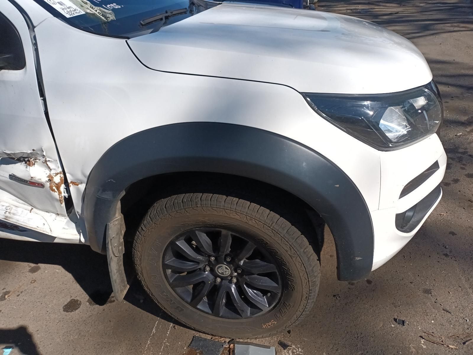 A White Truck with Black Wheels is Parked on the Side of the Road — South West 4WD Wreckers in Harristown, QLD