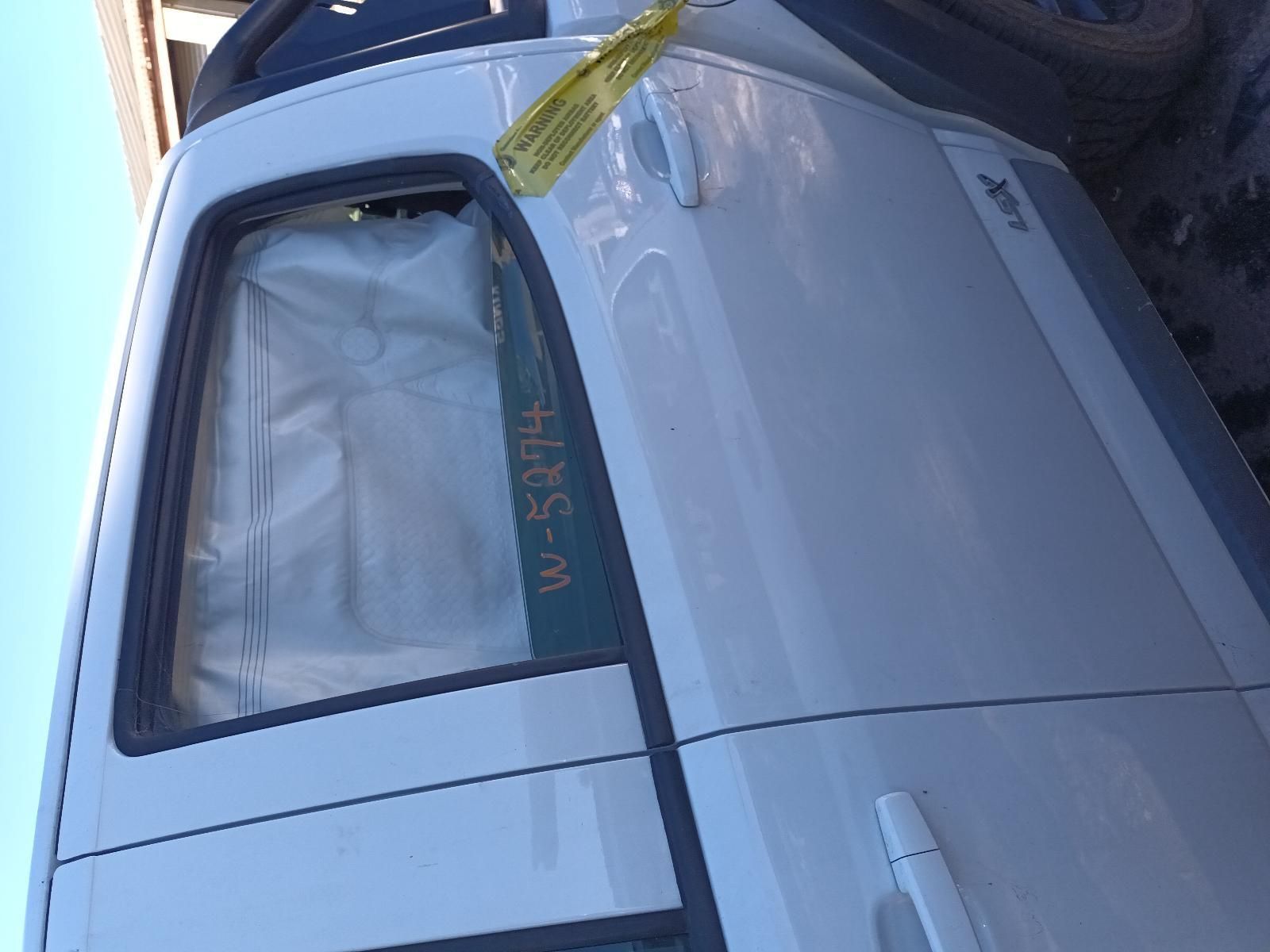 A White Van with a Yellow Tag on the Door — South West 4WD Wreckers in Harristown, QLD