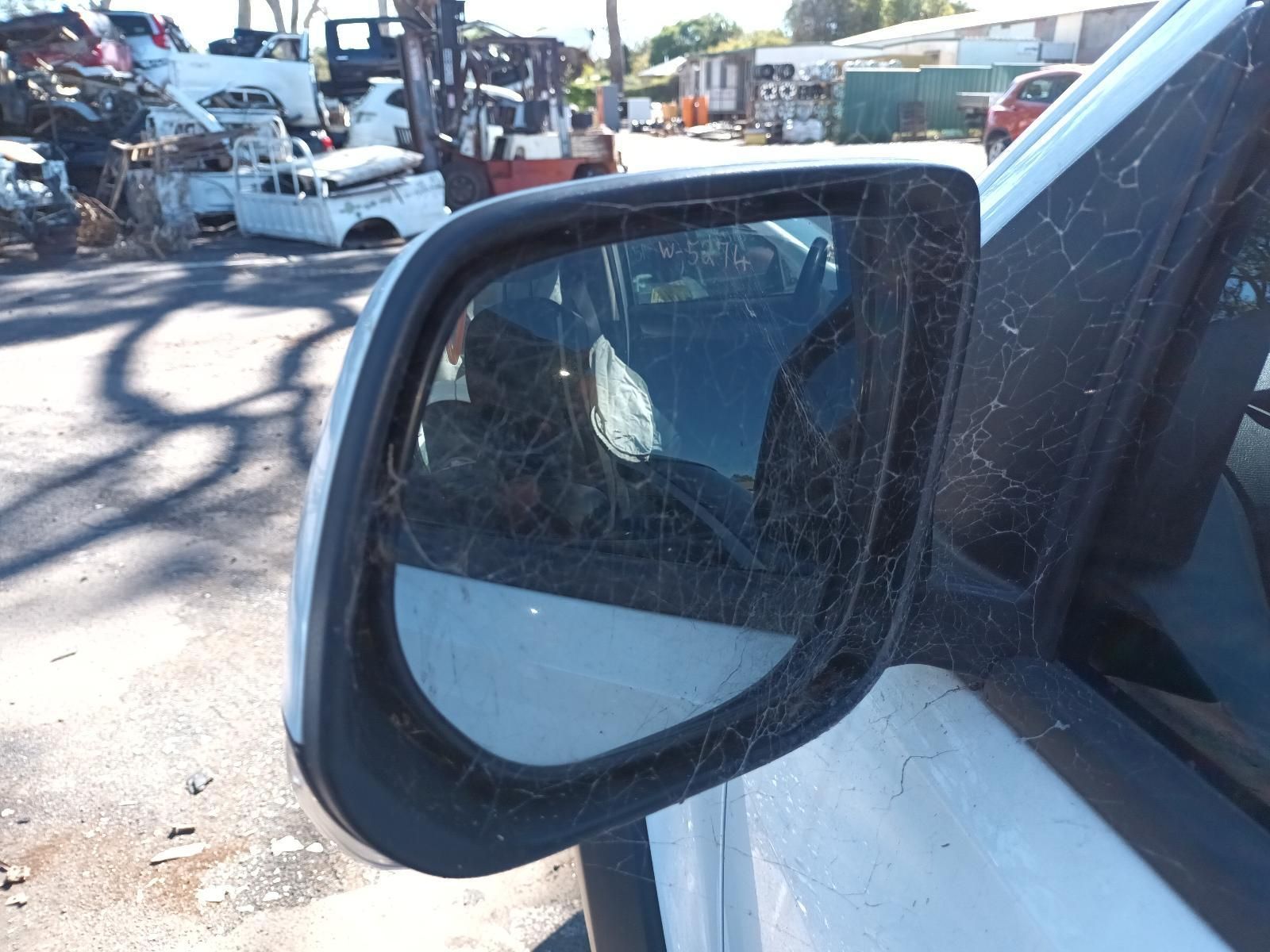 A Close Up of a Side View Mirror on a White Car — South West 4WD Wreckers in Harristown, QLD