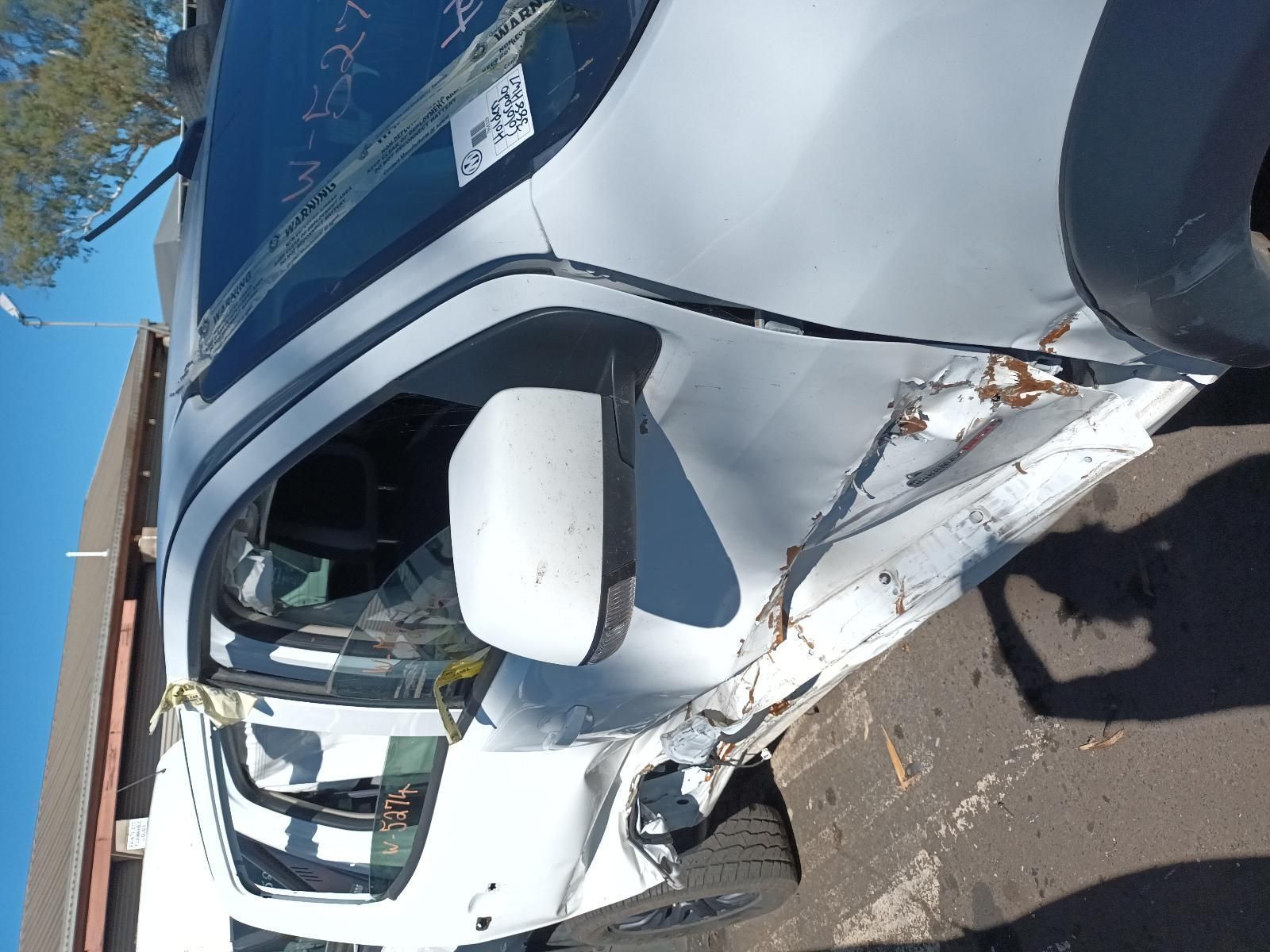A White Truck with a Broken Side Mirror is Parked on the Side of the Road — South West 4WD Wreckers in Harristown, QLD