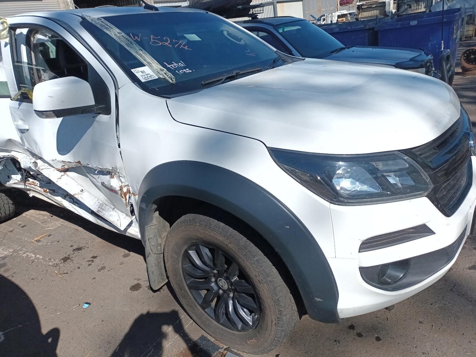A White Truck with Black Fender Flares is Parked on the Side of the Road — South West 4WD Wreckers in Harristown, QLD