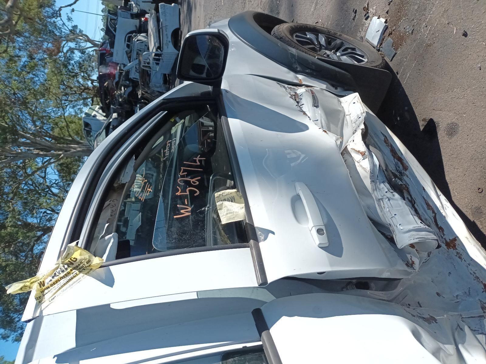A White Car That Has Been Damaged in an Accident — South West 4WD Wreckers in Harristown, QLD