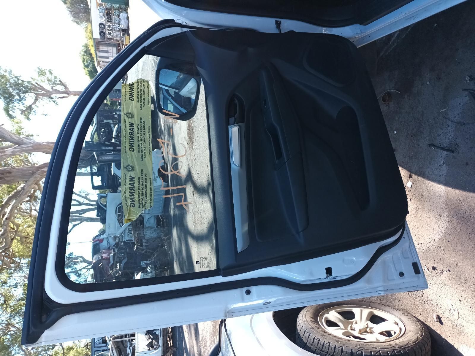 A White Car with the Door Open is Parked in a Parking Lot — South West 4WD Wreckers in Harristown, QLD