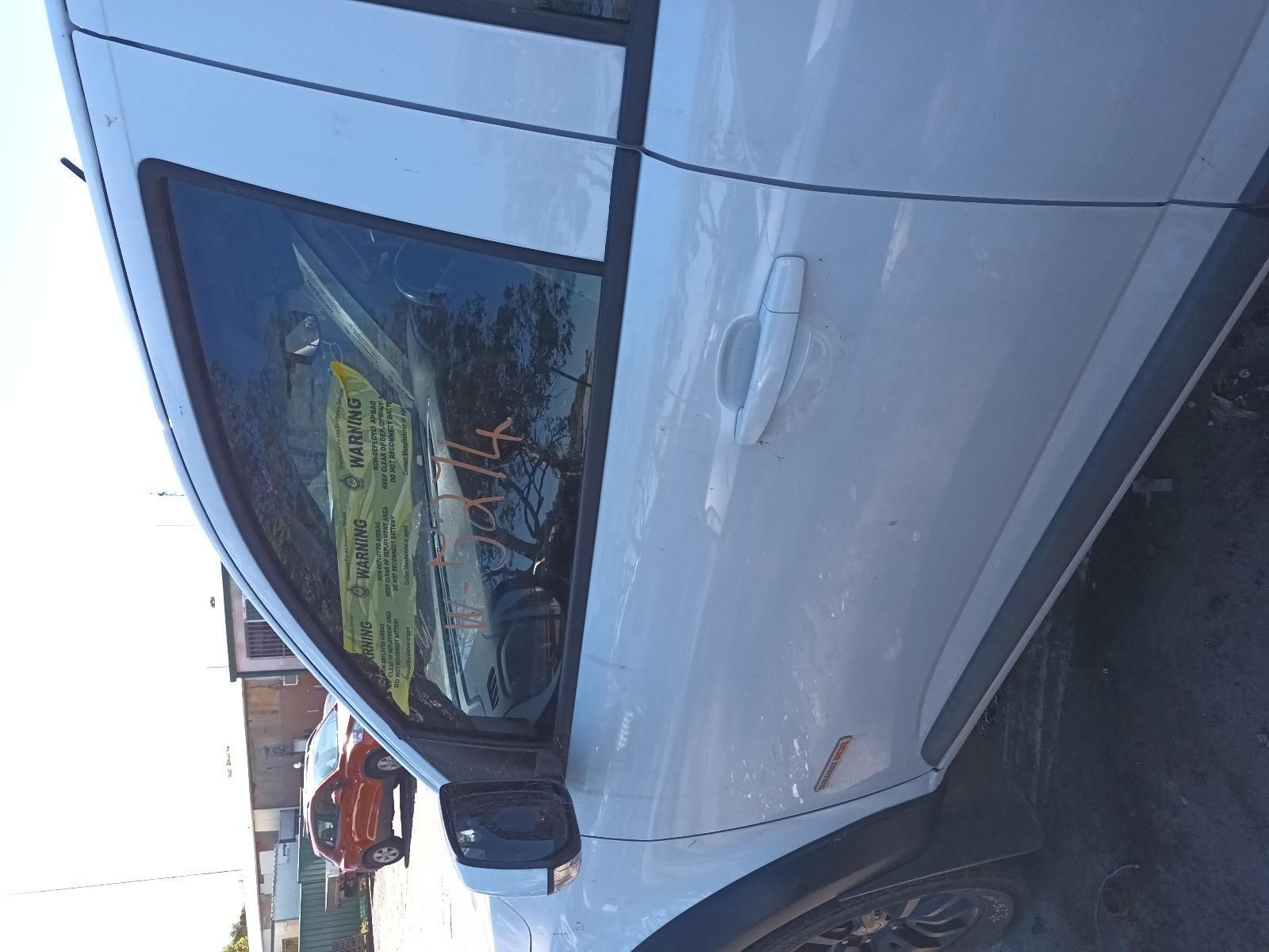 A White Car with a Yellow Sign on the Window is Parked in a Parking Lot — South West 4WD Wreckers in Harristown, QLD