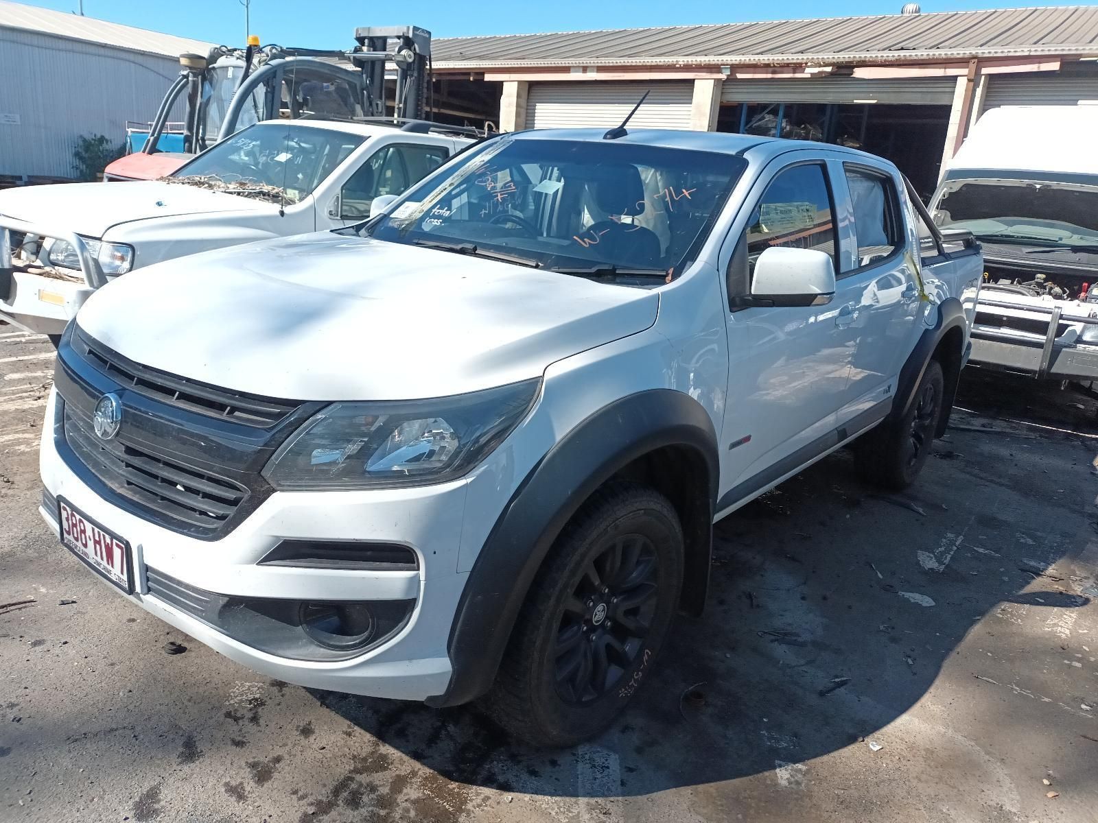A White Pickup Truck is Parked in Front of a Garage — South West 4WD Wreckers in Harristown, QLD