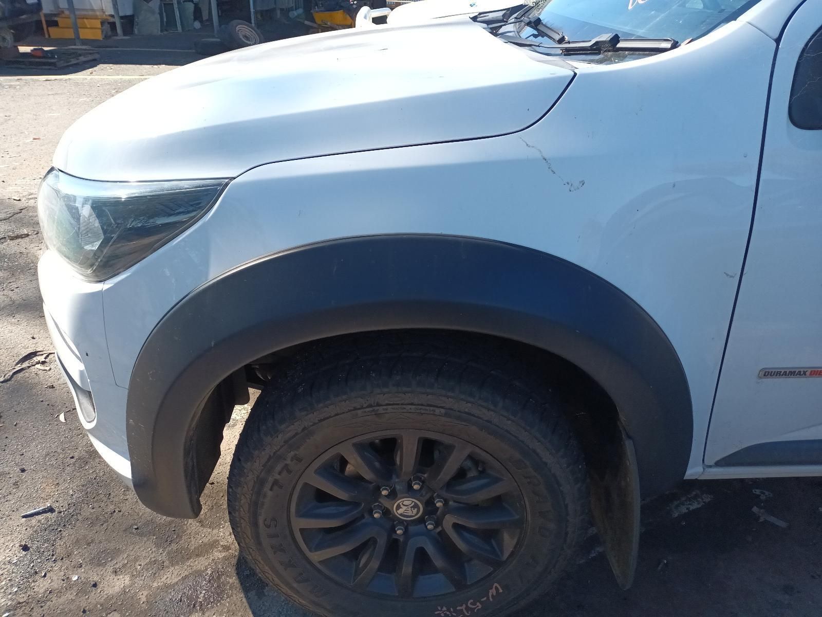 A White Truck with Black Fender Flares is Parked in a Parking Lot — South West 4WD Wreckers in Harristown, QLD