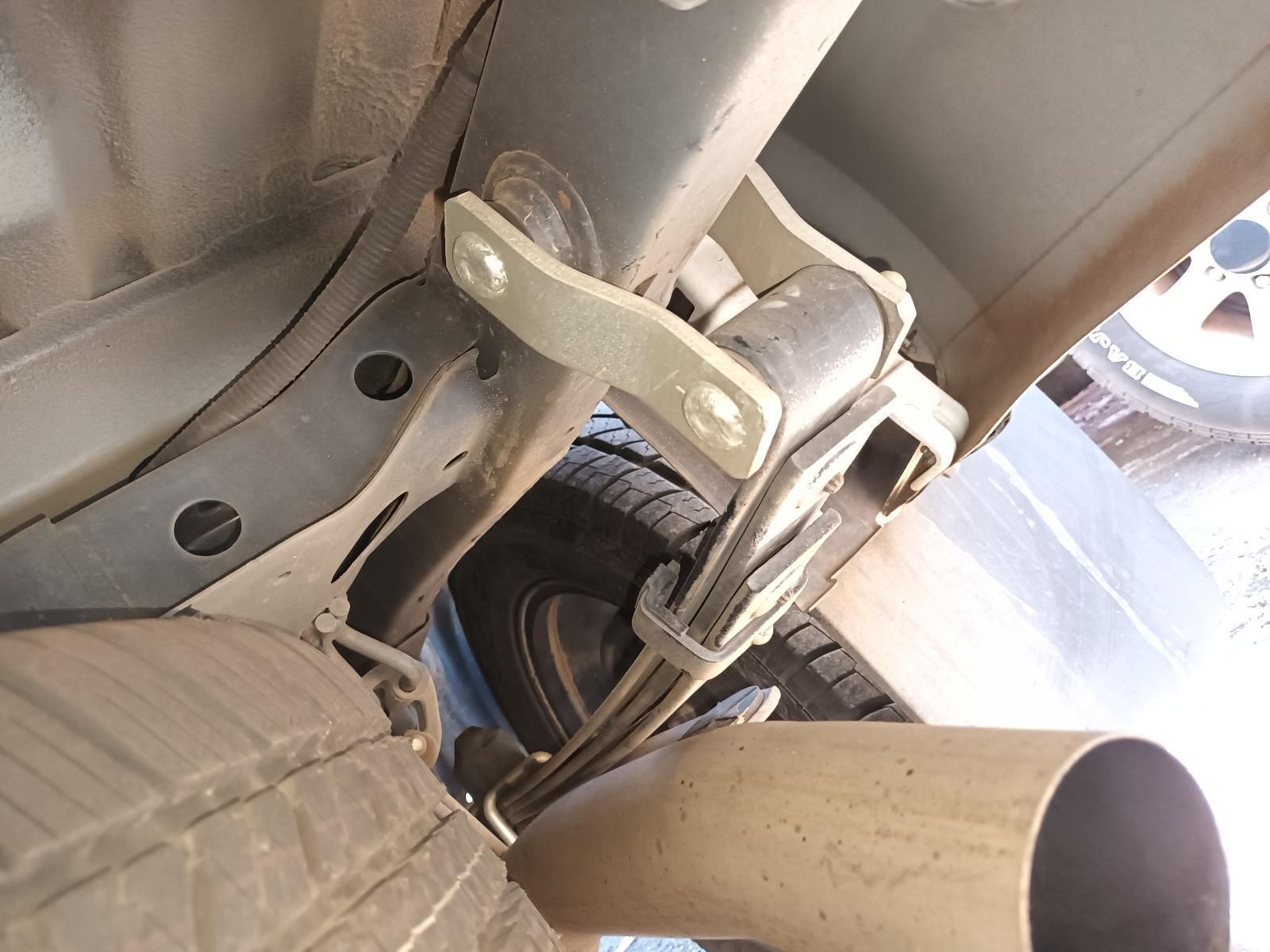 A Close Up of a Car Exhaust Pipe with a Tire in the Background — South West 4WD Wreckers in Harristown, QLD