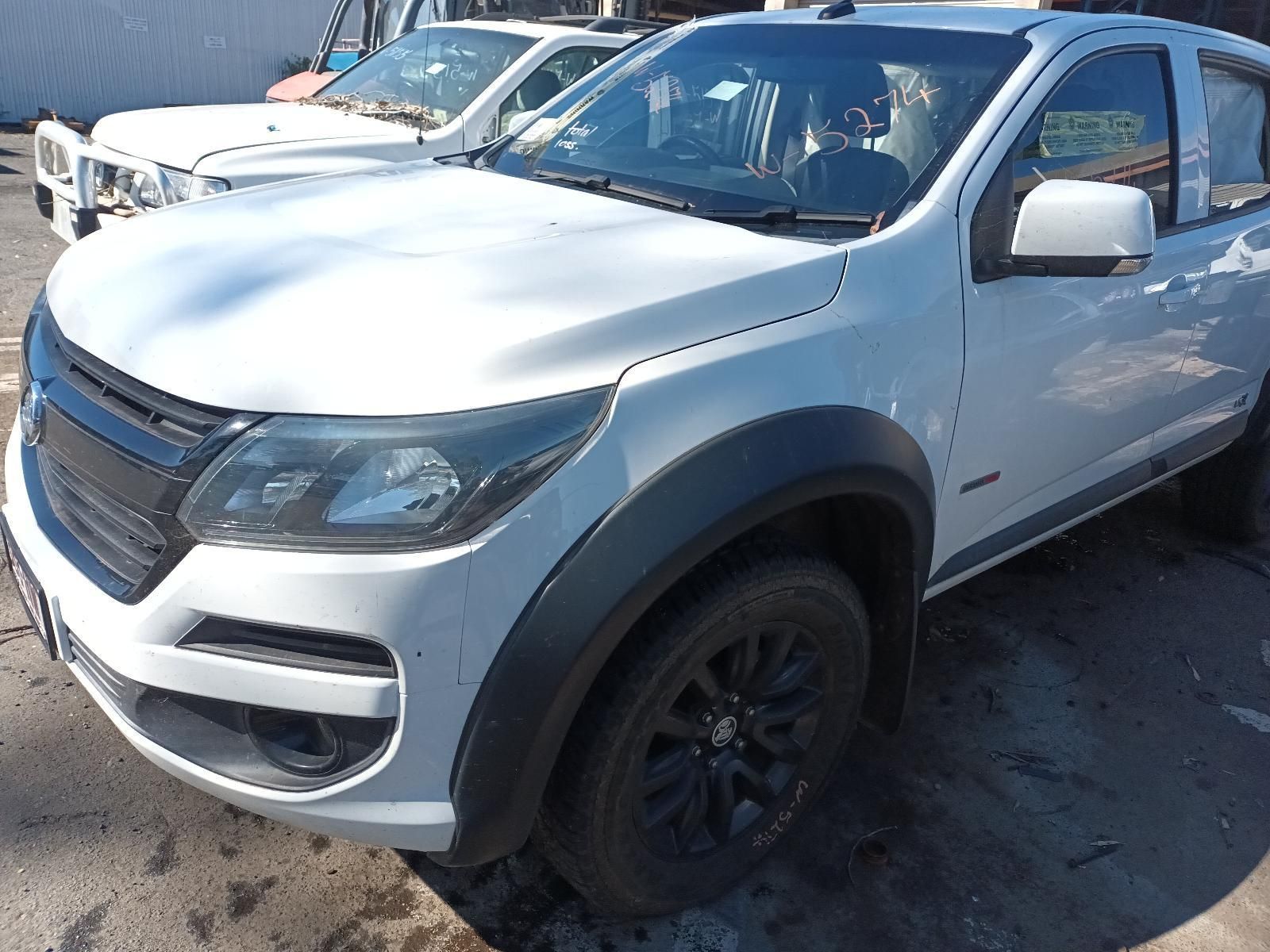 A White Truck with Black Fender Flares is Parked in a Parking Lot — South West 4WD Wreckers in Harristown, QLD