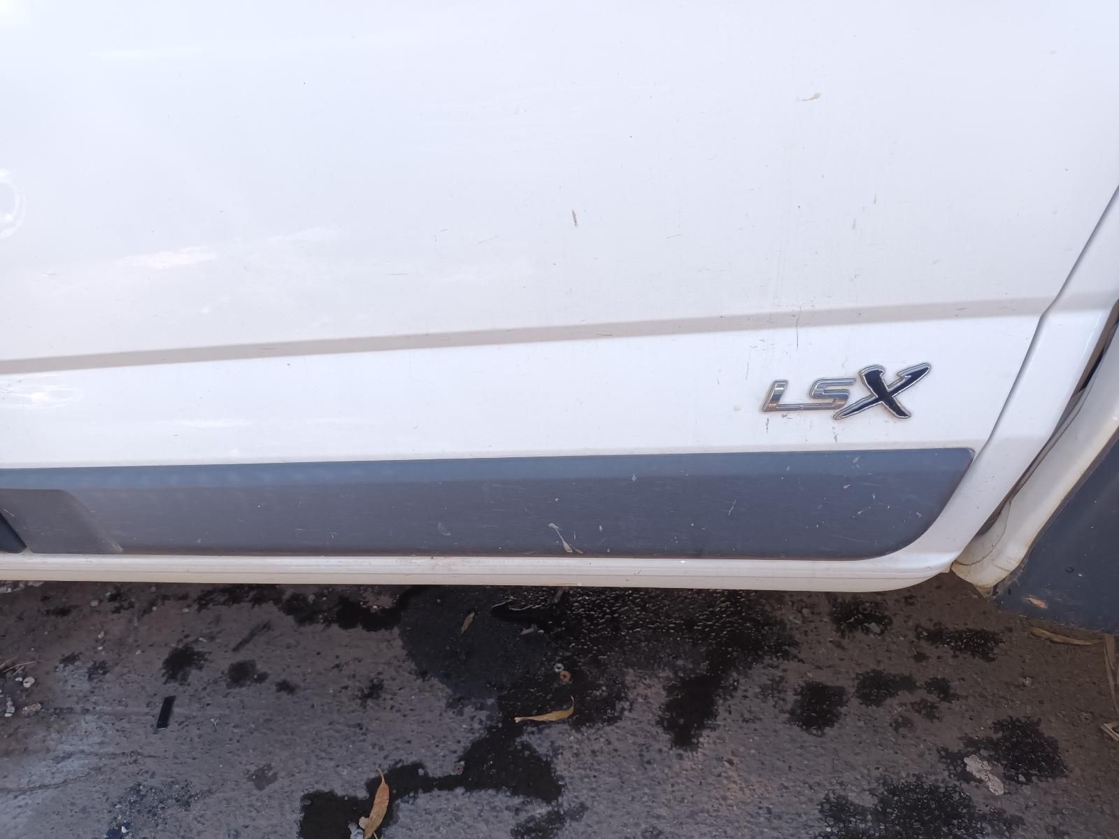 A White LSX Truck is Parked on the Side of the Road — South West 4WD Wreckers in Harristown, QLD