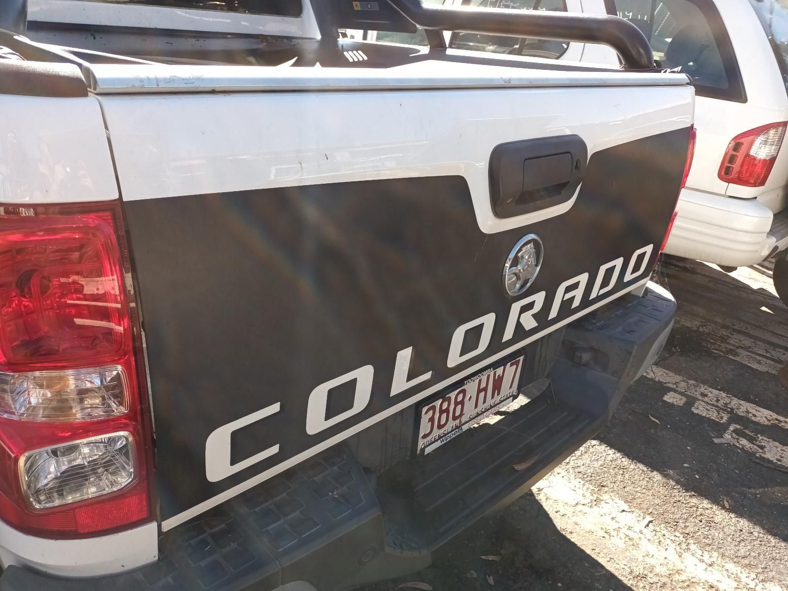 A Black and White Colorado Truck is Parked in a Parking Lot — South West 4WD Wreckers in Harristown, QLD