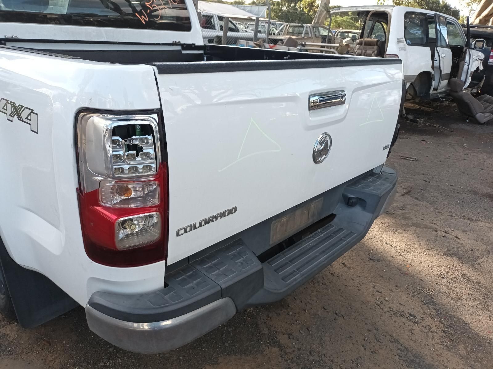 The Back End of a White Pickup Truck is Shown — South West 4WD Wreckers In Harristown, QLD