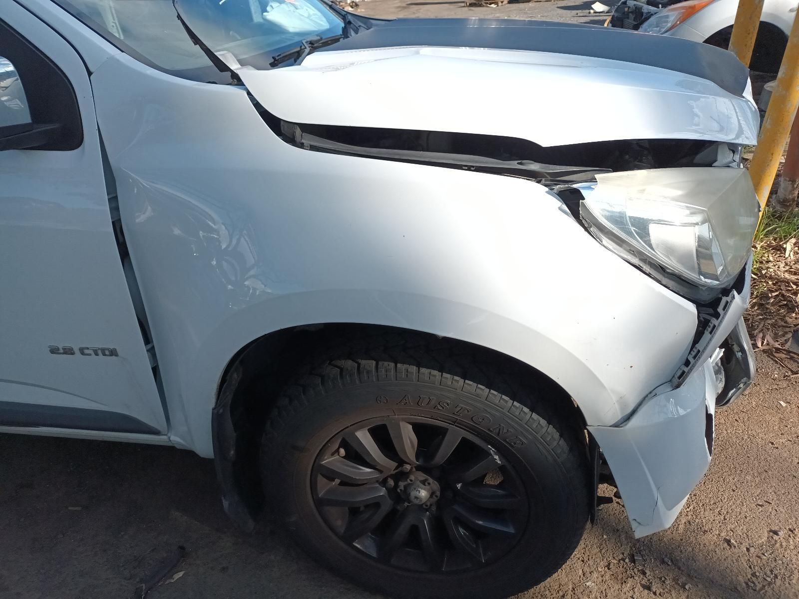 A White Truck With a Damaged Hood is Parked on the Side of the Road — South West 4WD Wreckers In Harristown, QLD
