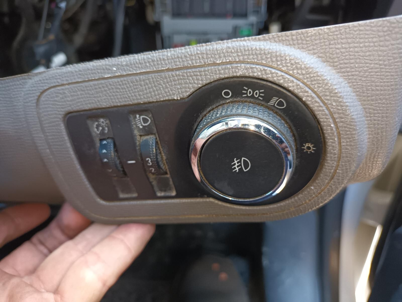 A Person is Holding a Light Switch in Their Hand — South West 4WD Wreckers In Harristown, QLD