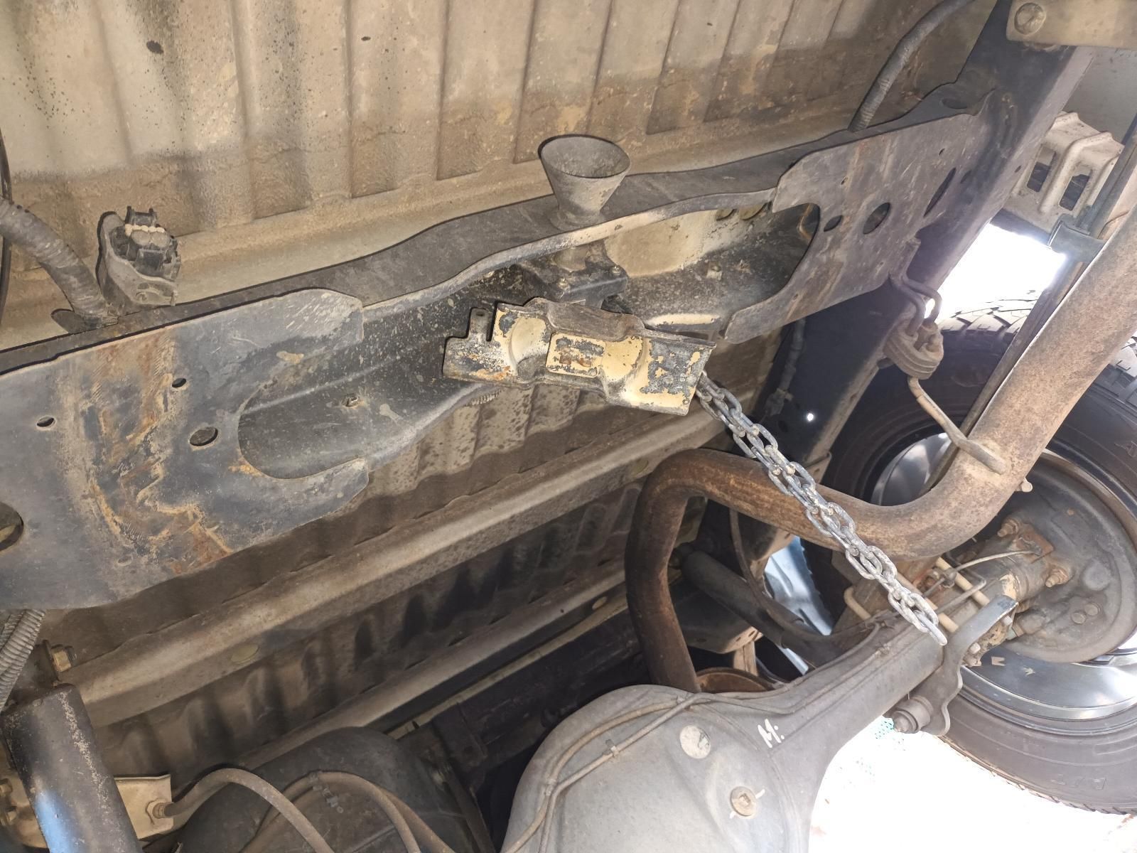 A Close Up of the Underside of a Car With a Chain Attached to It — South West 4WD Wreckers In Harristown, QLD