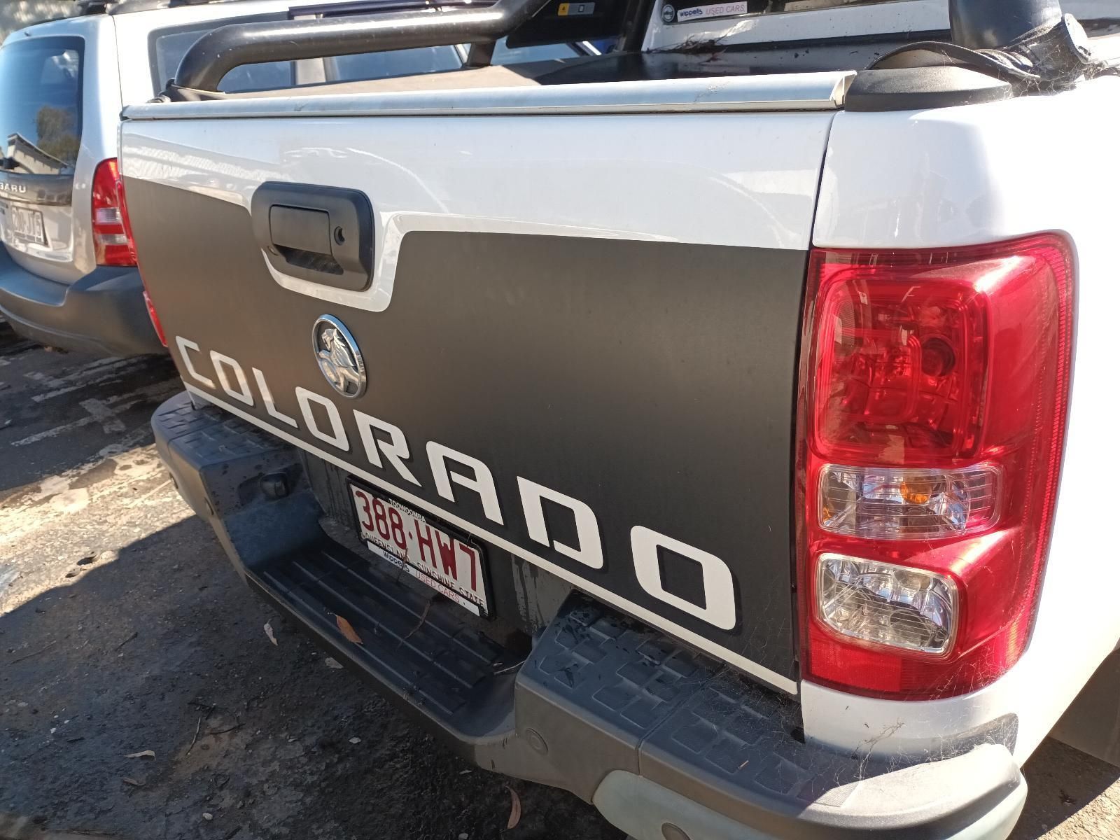 A White Colorado Truck is Parked in a Parking Lot — South West 4WD Wreckers In Harristown, QLD