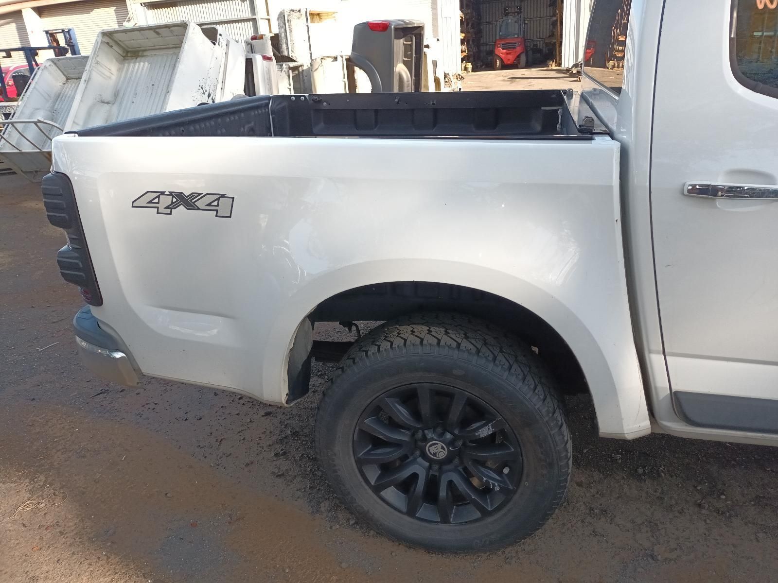 A White Truck With Black Wheels and Tires is Parked on the Side of the Road — South West 4WD Wreckers In Harristown, QLD