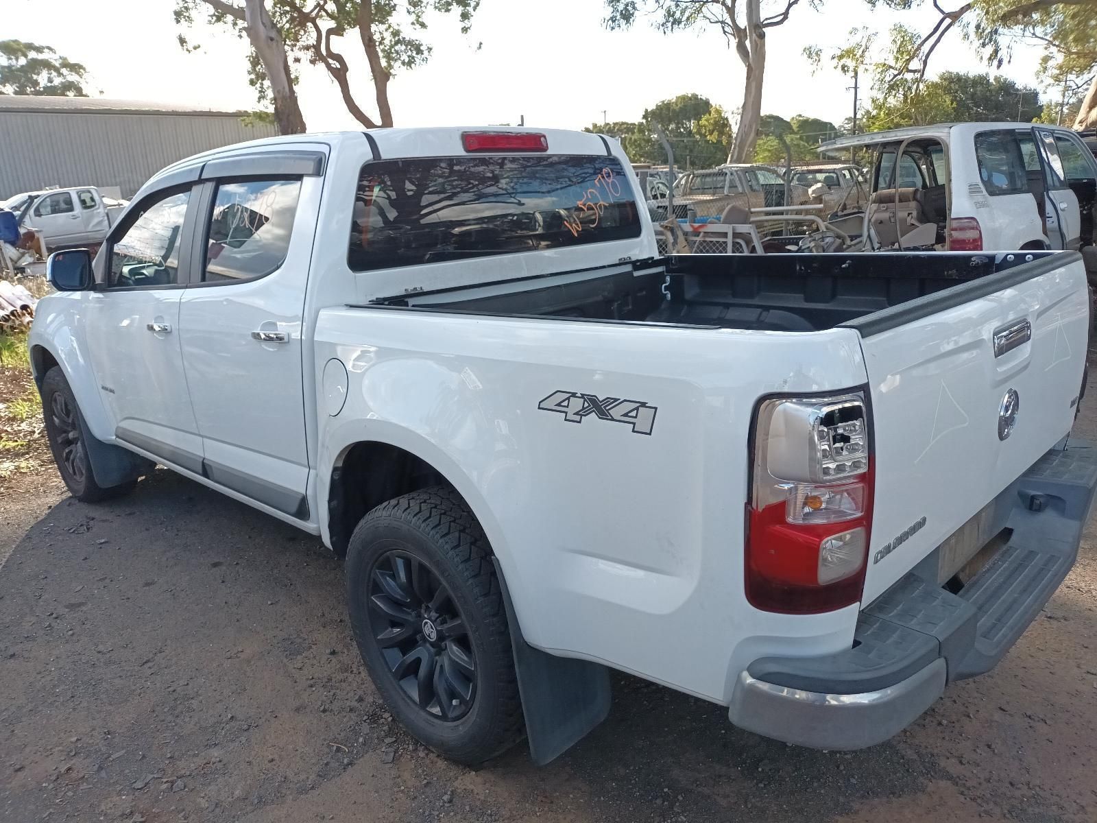 A White Pickup Truck is Parked on the Side of the Road — South West 4WD Wreckers In Harristown, QLD