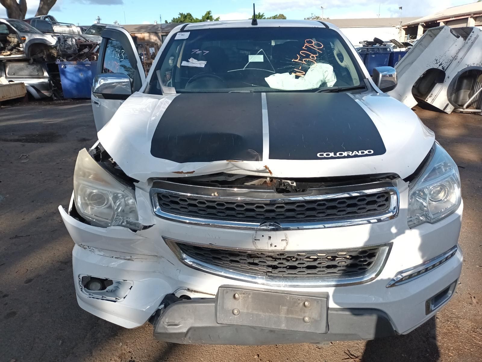 A White Car With a Black Stripe on the Hood is Parked in a Lot — South West 4WD Wreckers In Harristown, QLD