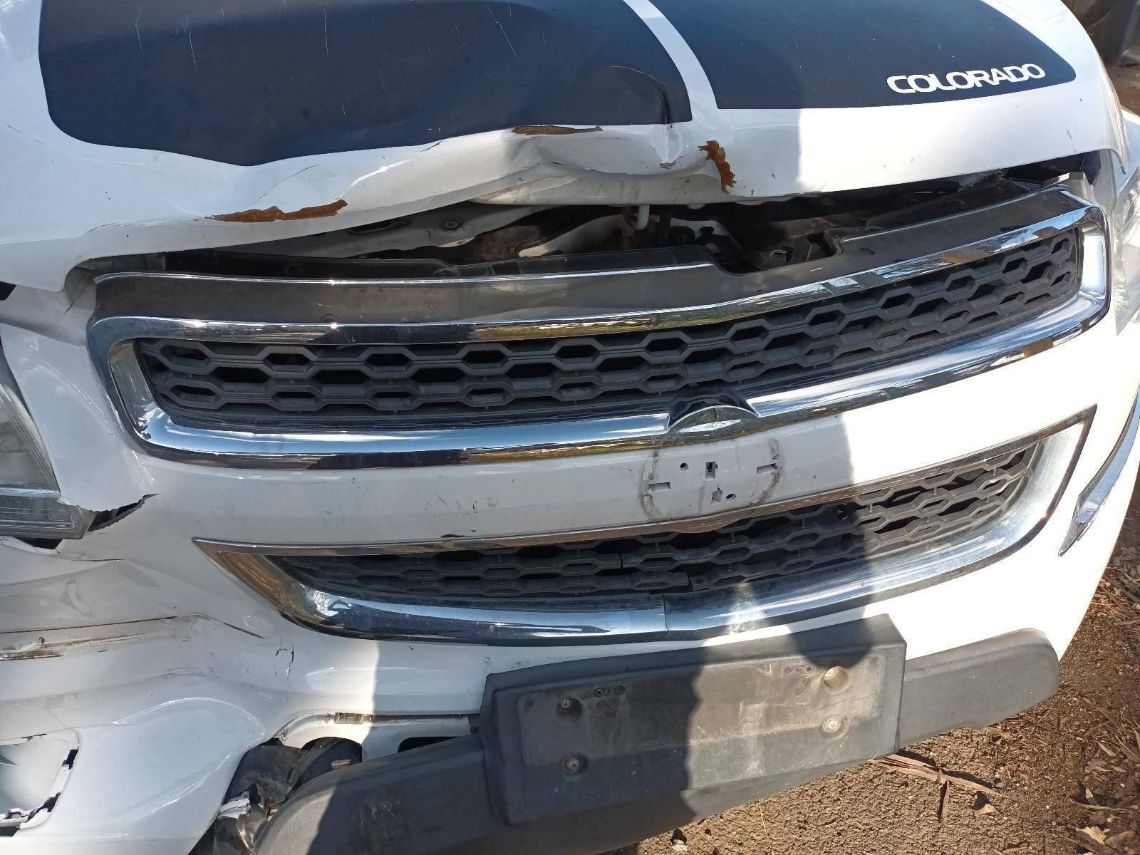 A White Chevrolet Colorado With a Black Stripe on the Hood — South West 4WD Wreckers In Harristown, QLD