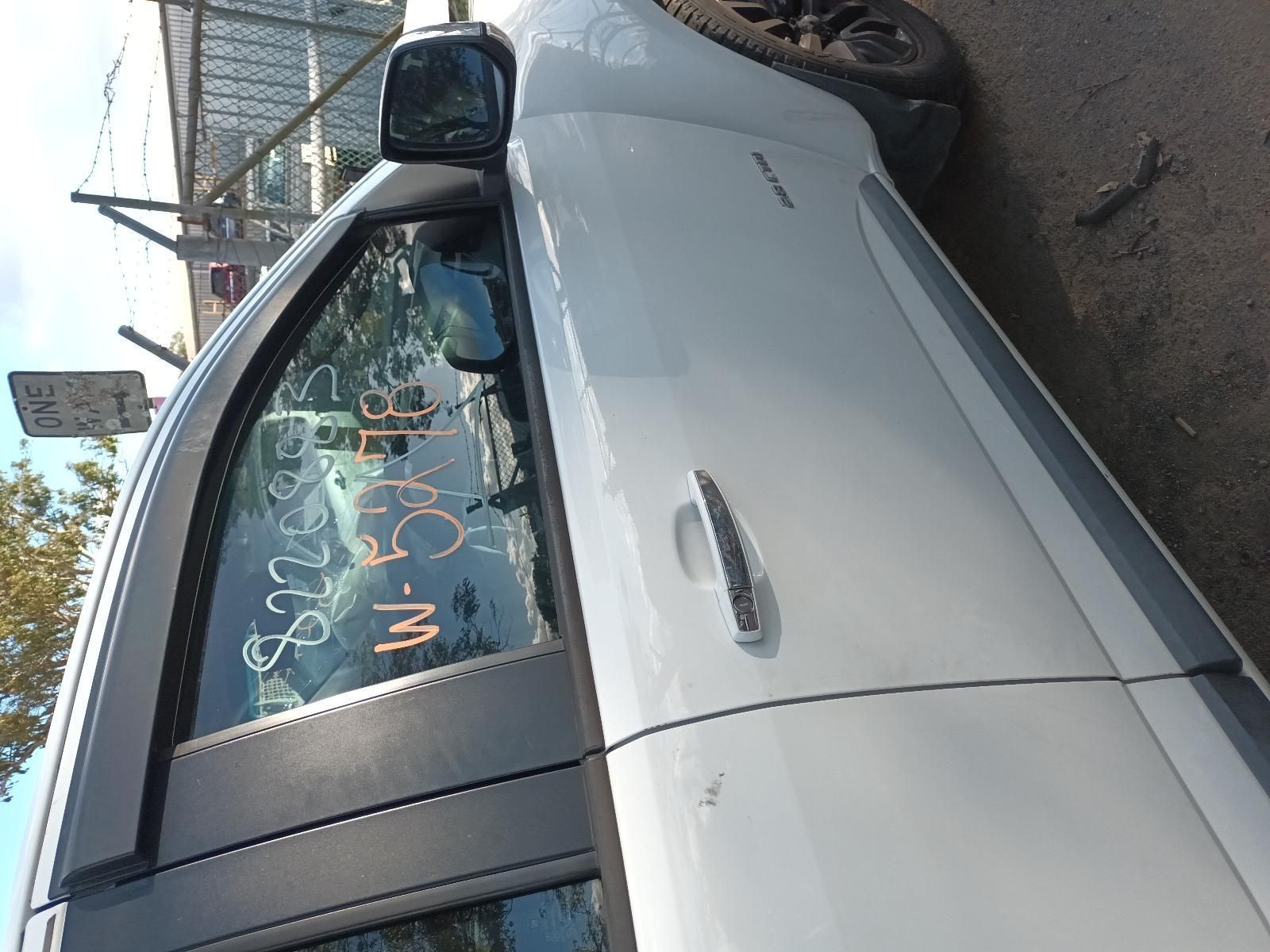 A White Car is Parked on the Side of the Road — South West 4WD Wreckers In Harristown, QLD