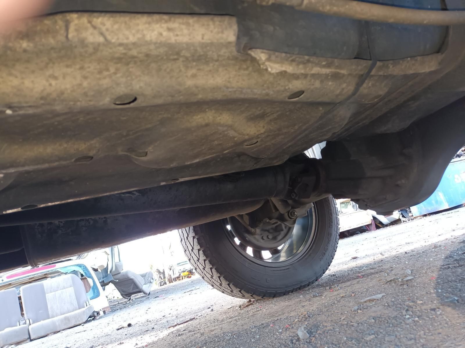 A Car is Parked on the Side of the Road and the Underside of the Car is Shown — South West 4WD Wreckers In Harristown, QLD
